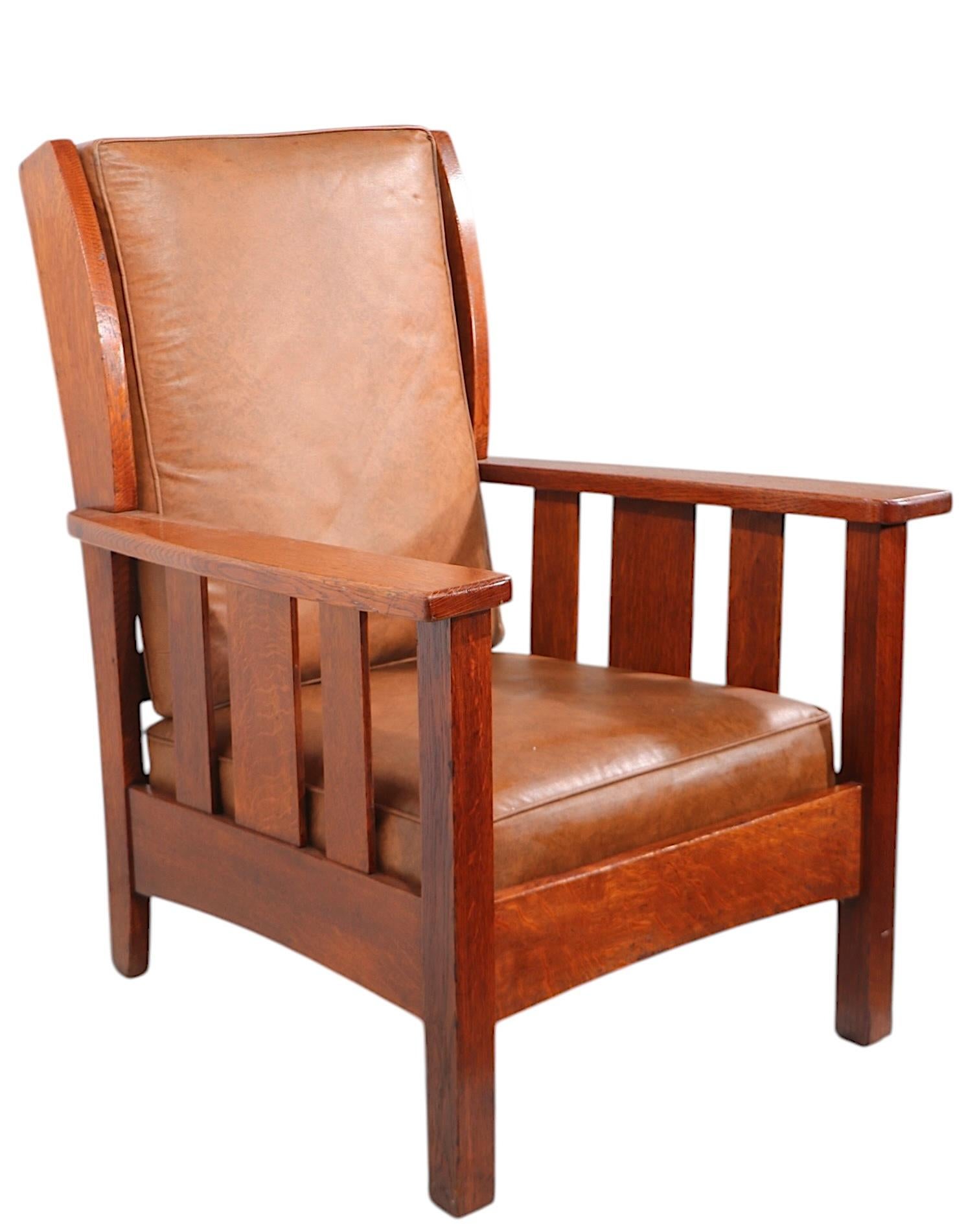 Great set of two Stickley Brothers Co., Quaint Furniture, Mission oak chairs to include a lounge chair, and the matching rocking chair. Nice large scale, classic Arts and Crafts lines, both chairs retain their original Quaint Furniture metal tags.