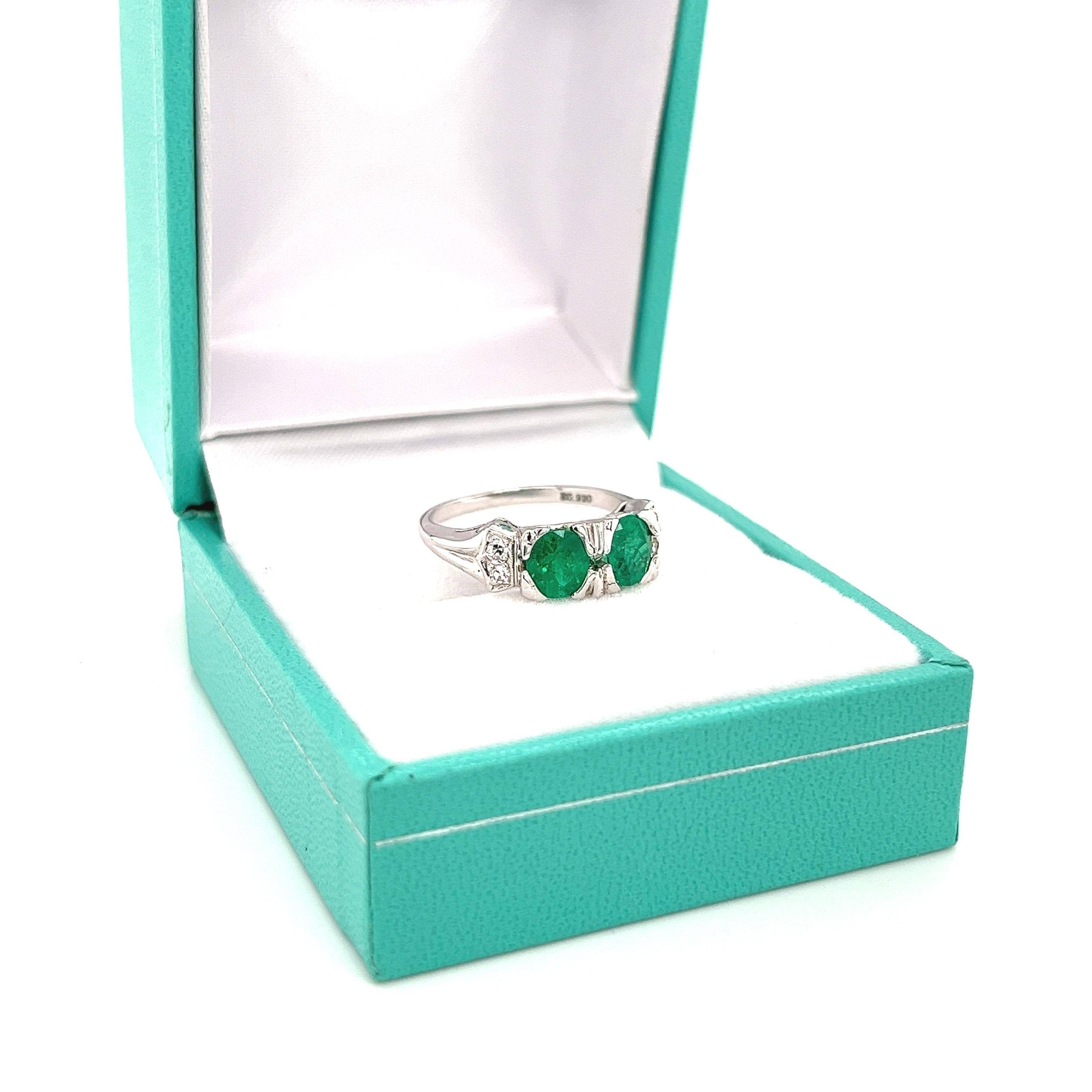 Art Deco inspired Colombian Emerald ring of 0.92 carats. The emerald carat is engraved on the inside of the ring setting. The Emeralds are half-bezel tension set in 18k solid white gold. The Half bezel mounting the emeralds on the face is 5.7mm in