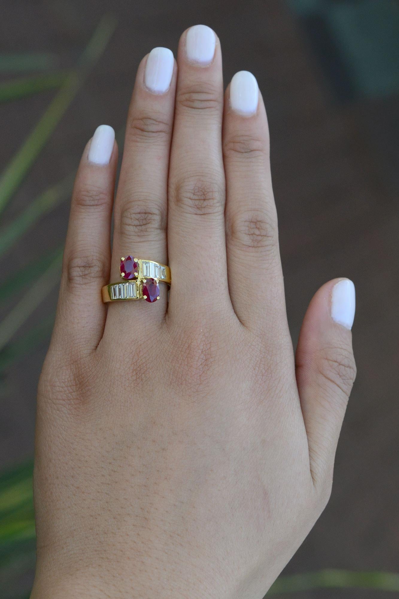 This ruby and diamond engagement ring is both gorgeous and groovy! The succeeding rows of glimmering baguette diamonds ascend towards 2 boisterous rubies that show off a desirable, rich red color. and juicy luster. A marvelous Mid Century 2 stone