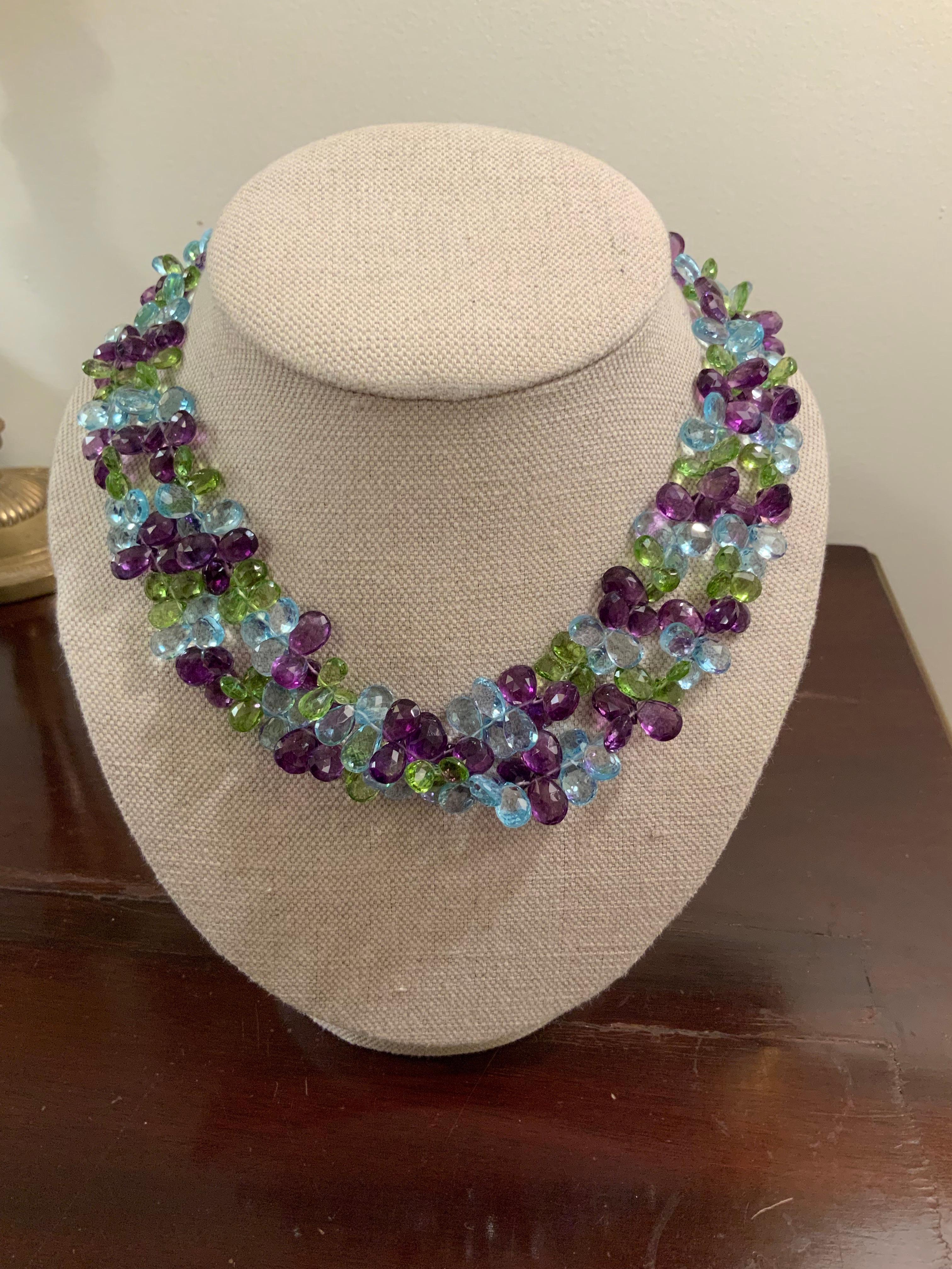Elegant 2 strand faceted pear shaped Briolette Necklace with Blue Topaz, Peridot and Amethyst finished with 18kt White Gold Clasp.  The faceted flat briolettes weigh approximately 520 carats.

The Necklace measure 17 inches when twisted