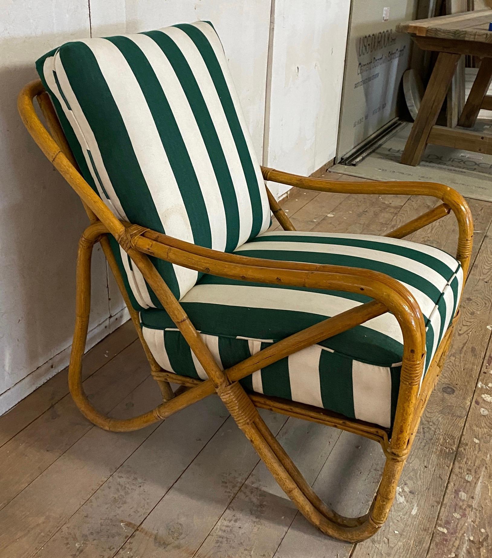 The 2 strand wicker/rattan club chair has rounded arm that comes with green and white wide striped canvas seat and back cushions. The side has pretzel shape x design.  This lounge chair offers style and comfort for any porch or patio.
The seat