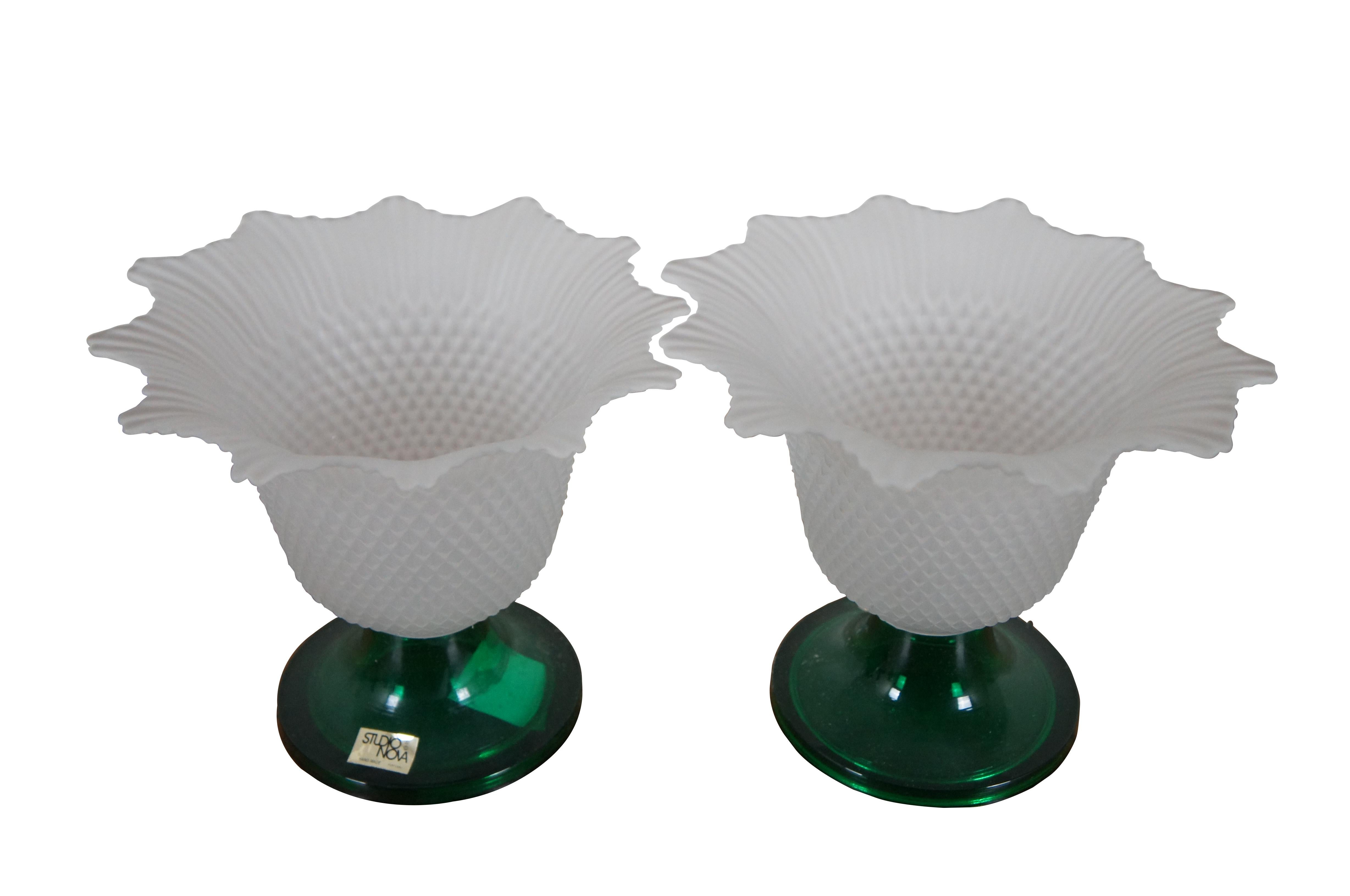 Pair of vintage votive / tea light candle holders by Studio Nova, featuring round green bases and white frosted glass tops shaped like a flower and textured like a pineapple topped with flared leaves. Hand made in Portugal.

Dimesions:
7.25