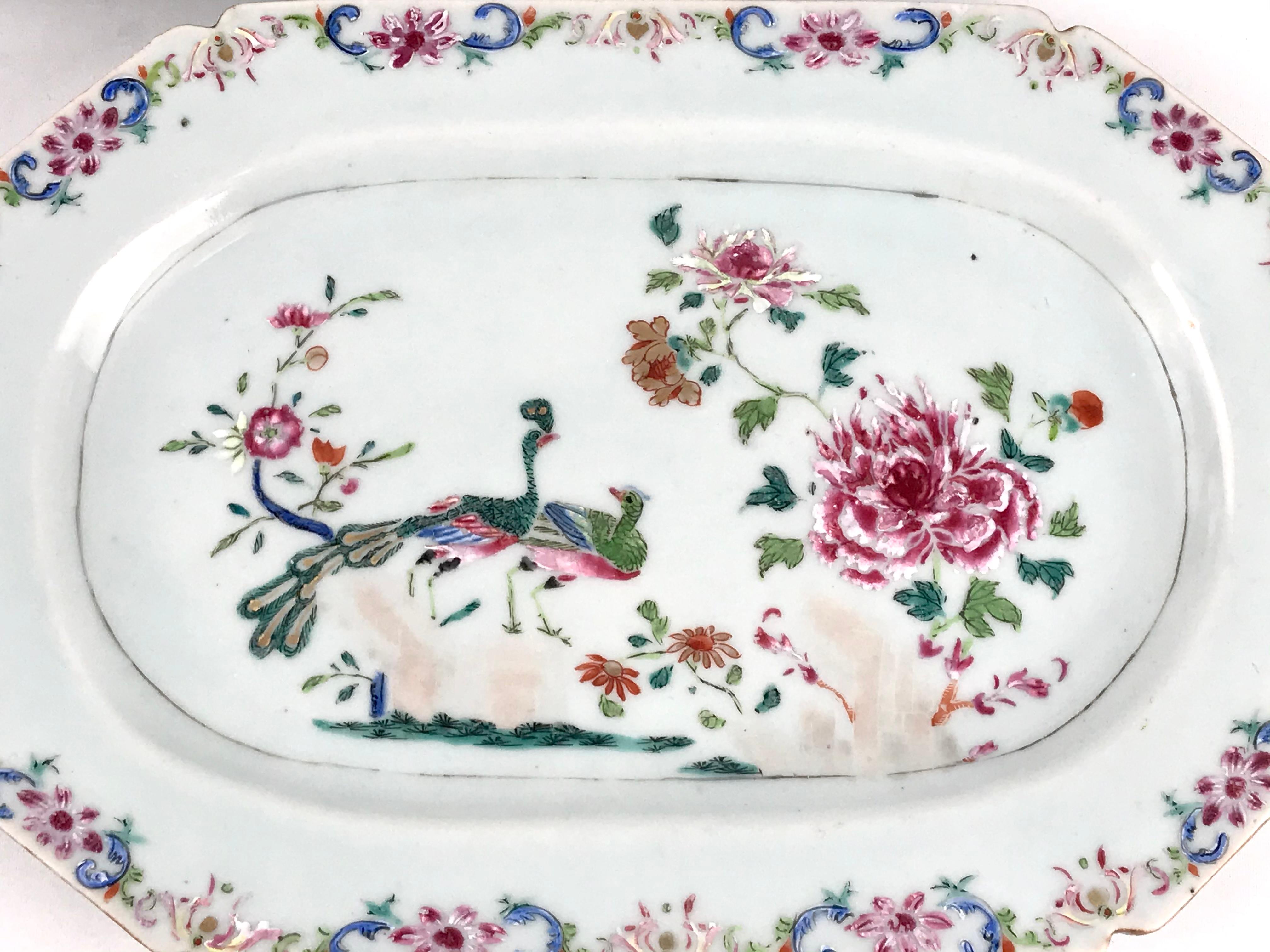 A Pair of Chinese famille rose 18th century Porcelain double peacock Platters. Qianlong
Hand decorated in the classic pattern showing a peacock and peahen perched on rockwork in a garden growing with large, lush peony blooms alongside smaller