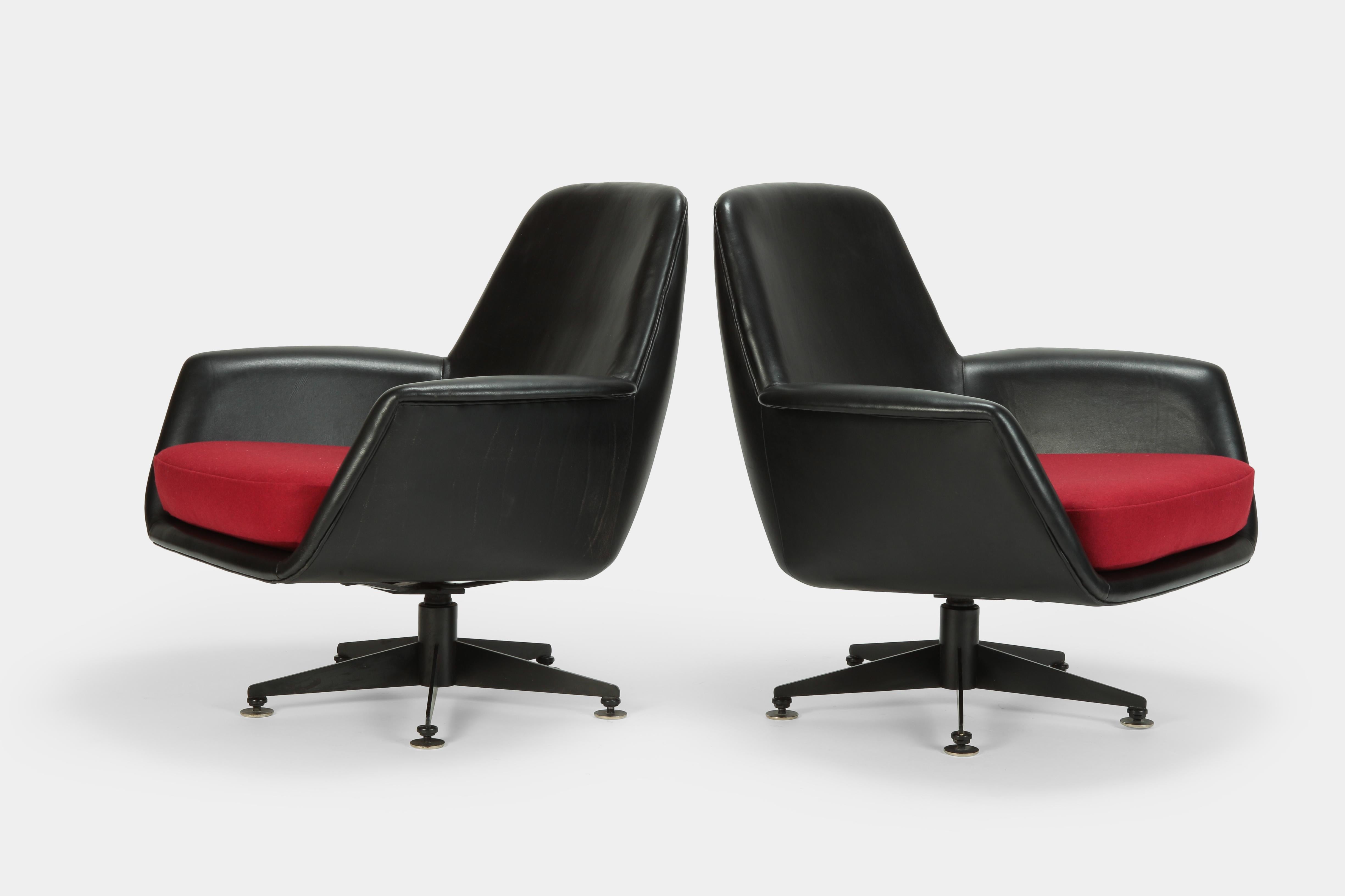 Two elegant lounge chairs manufactured by DEM in the 1960s in Switzerland. The shells are covered with fine, black leather and the cushions are also newly covered with a red lovely flannel fabric.