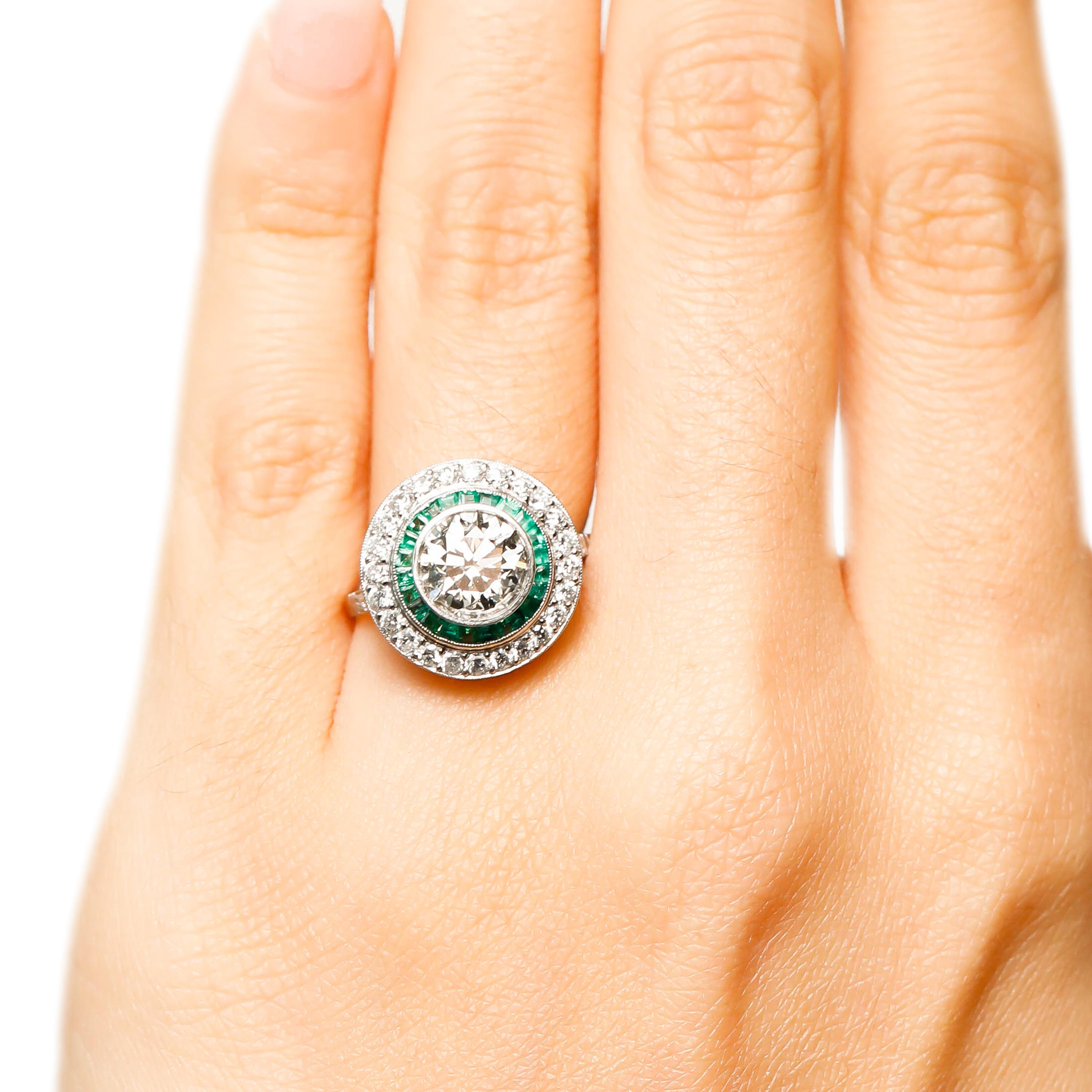 Round Cut Diamond and Emerald Cocktail Ring in Platinum Fine Engagement Jewelry

Propose to her with this bedazzling round diamond halo ring. Round Center stone is embellished on top, surrounded with a cluster of princess cut vivid green emeralds