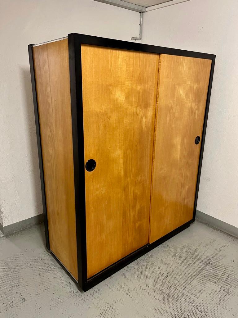 2 Sliding doors wardrobe made of teak wood by Swiss designer Kurt Thut, sold at Teo Jakob Furniture Design Store in Geneva, Switzerland 1959.
Very good condition. Left part with shelves and right part with wardrobe.
Nice black circular handle. Kind