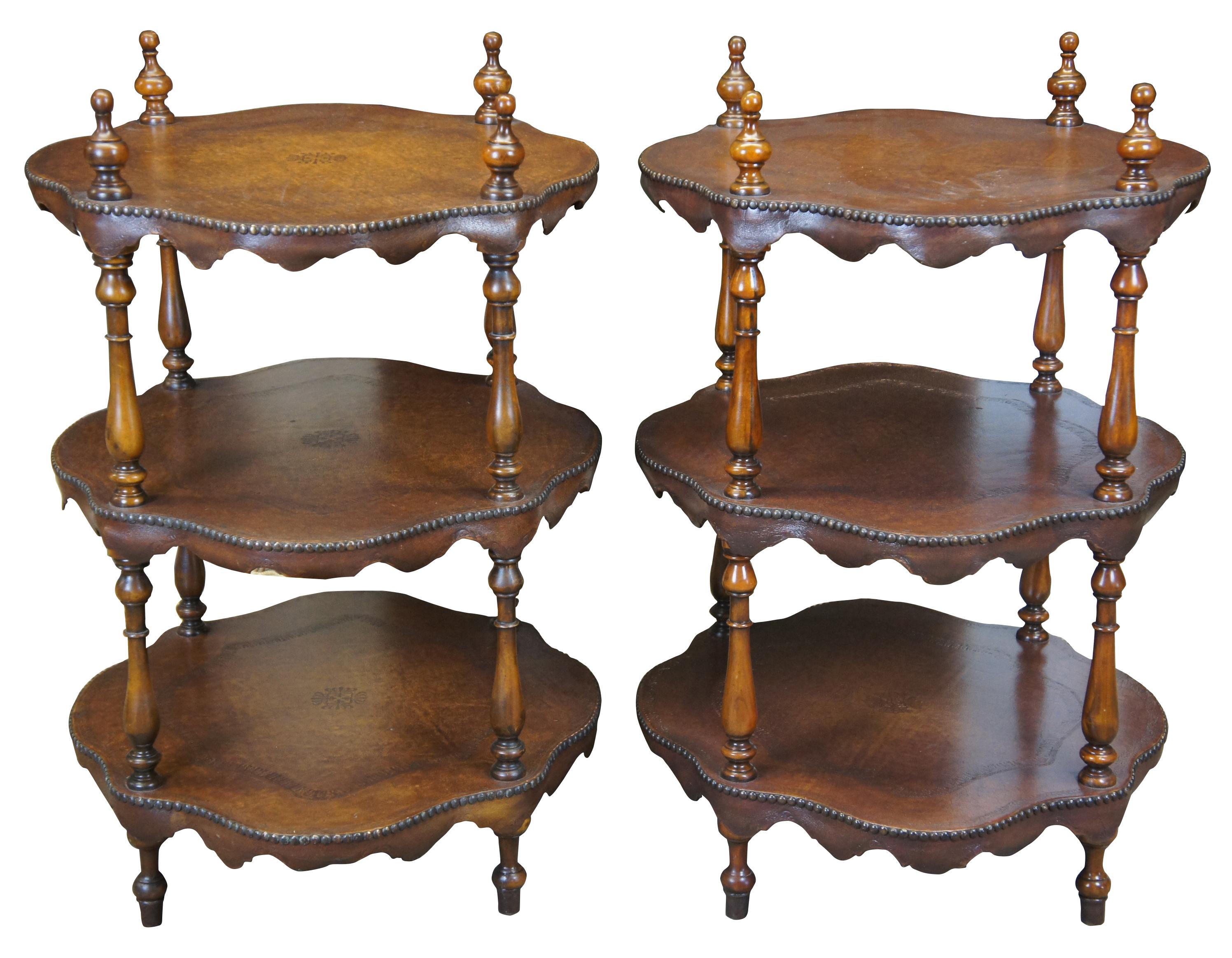 Theodore Alexander tiered leather tables, circa 1980s. Features three turtle top table surfaces, supported by turned ballisters. Includes tooled leather and nailhead trim. 5033-003, handmade in Vietnam.
   
Surface Height - 29.75