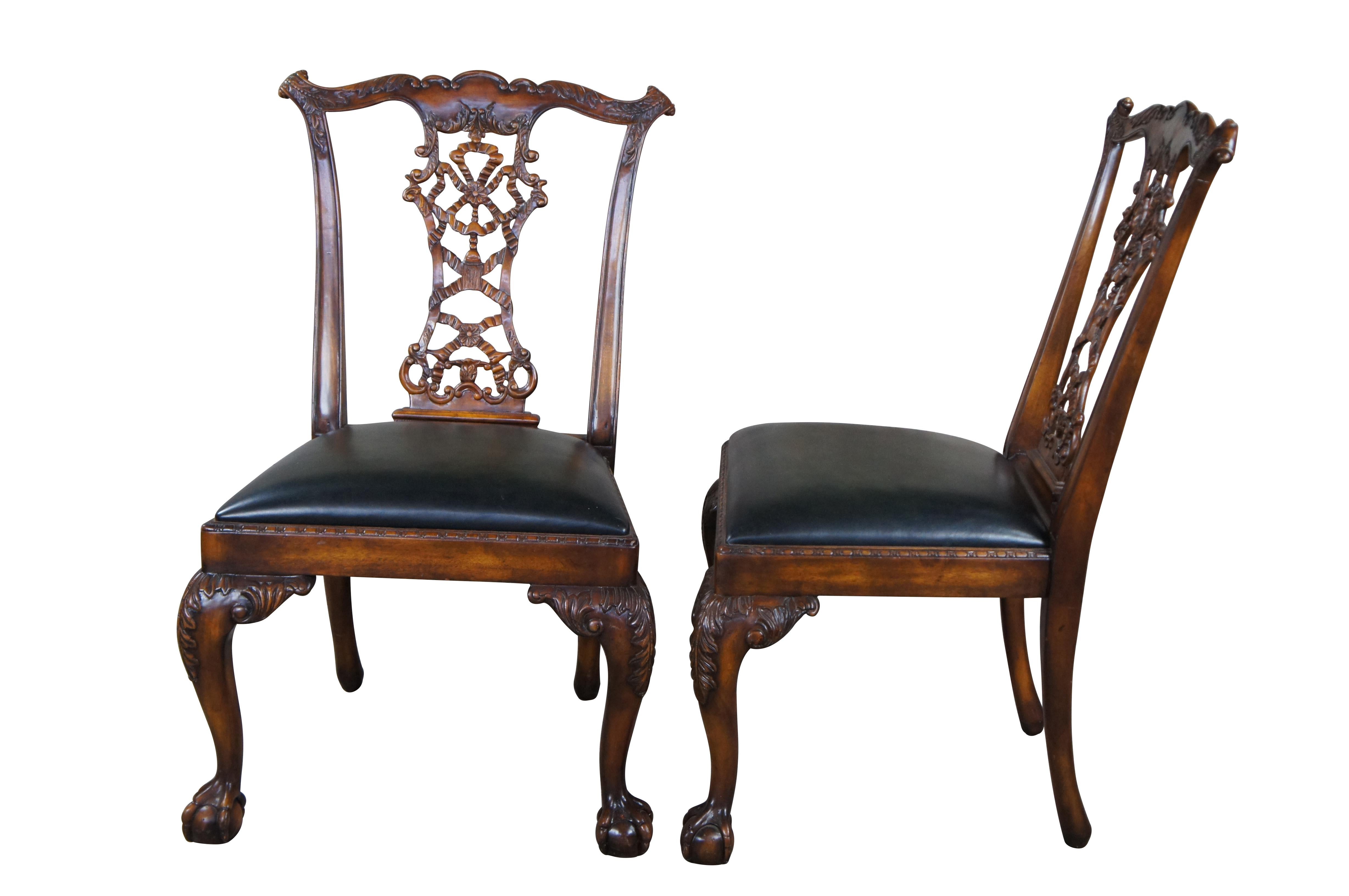 Pair of Theodore Alexander Chippendale Dining Side Chairs.  Features a serpentine crest rail with cared ears over an ornate pierced and ribboned back splat.  Each chair has a green leather seat surrounded by beaded accents over cabriole legs with