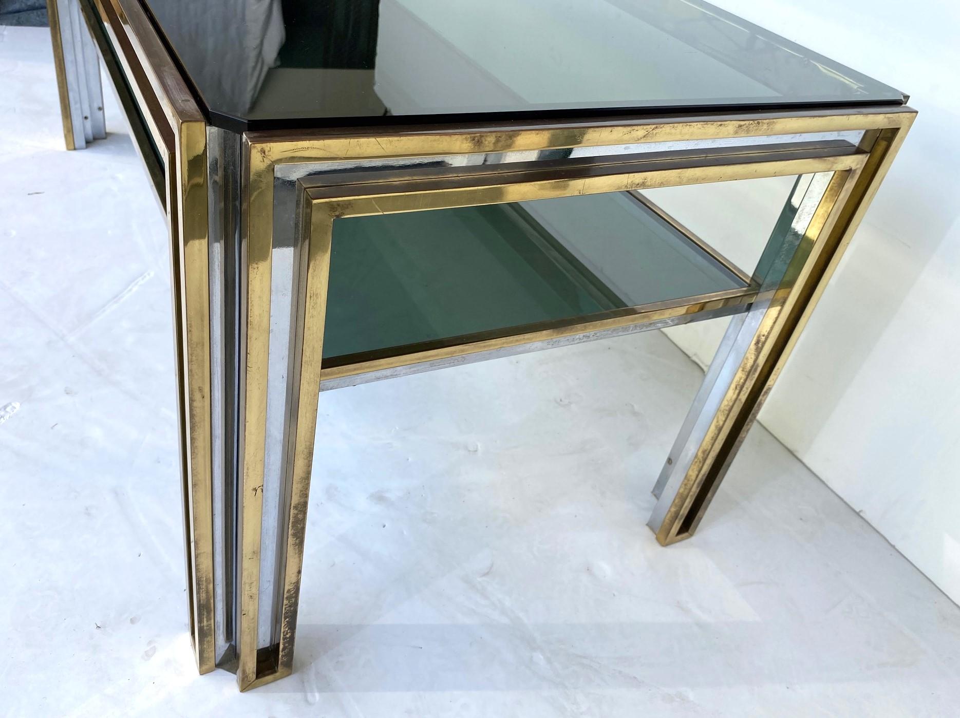 An Italian 2-tier chrome and brass coffee table with tinted glass.
