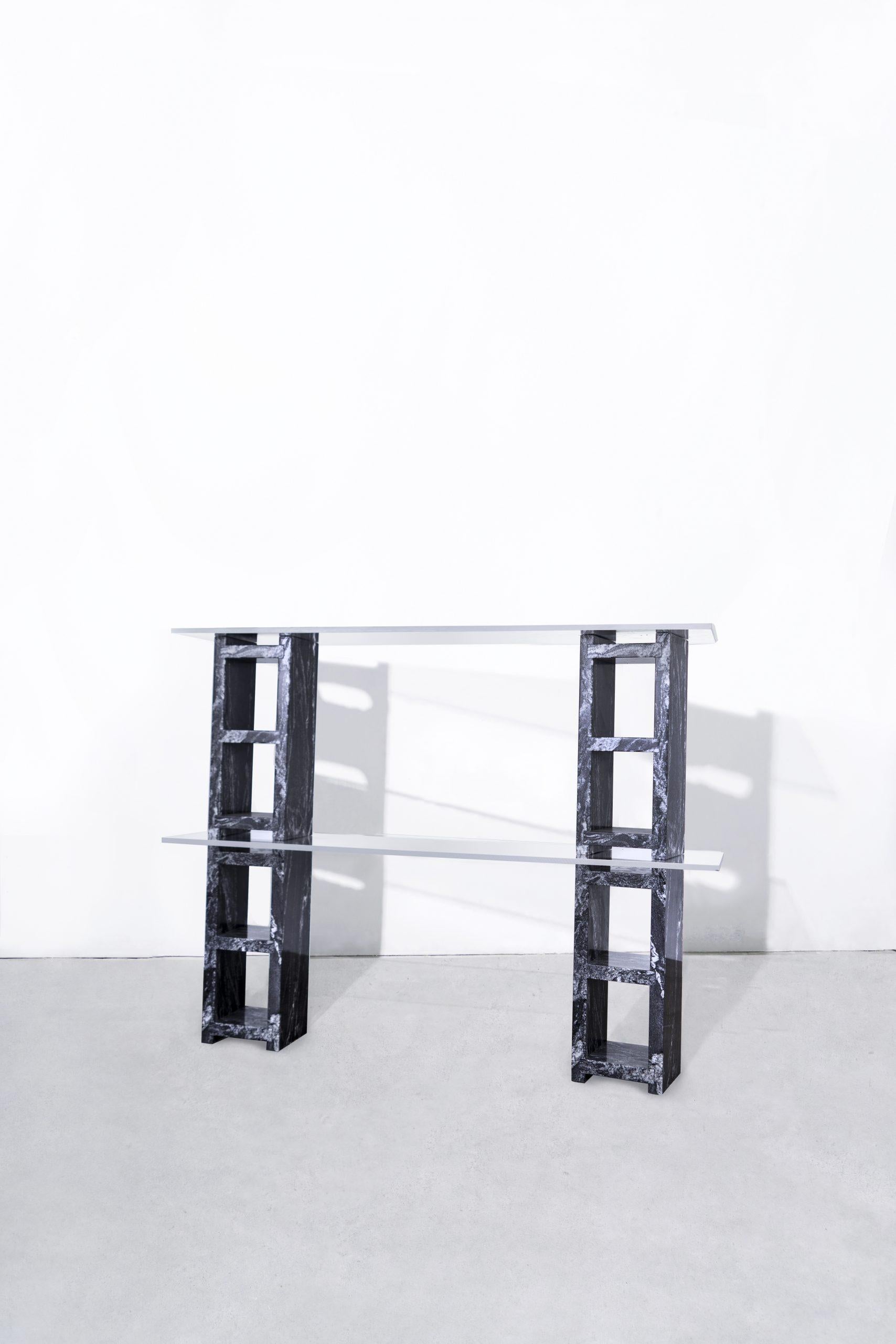 4 water jet cut, hand-polished nero marquina marble blocks, supporting 2 tempered glass shelves.
Starphire glass shelves.
Modular.
Made to order in nyc.

Dimensions
Cinder Block length 18.75?
Cinder block width 7.5” 
Cinder block thickness