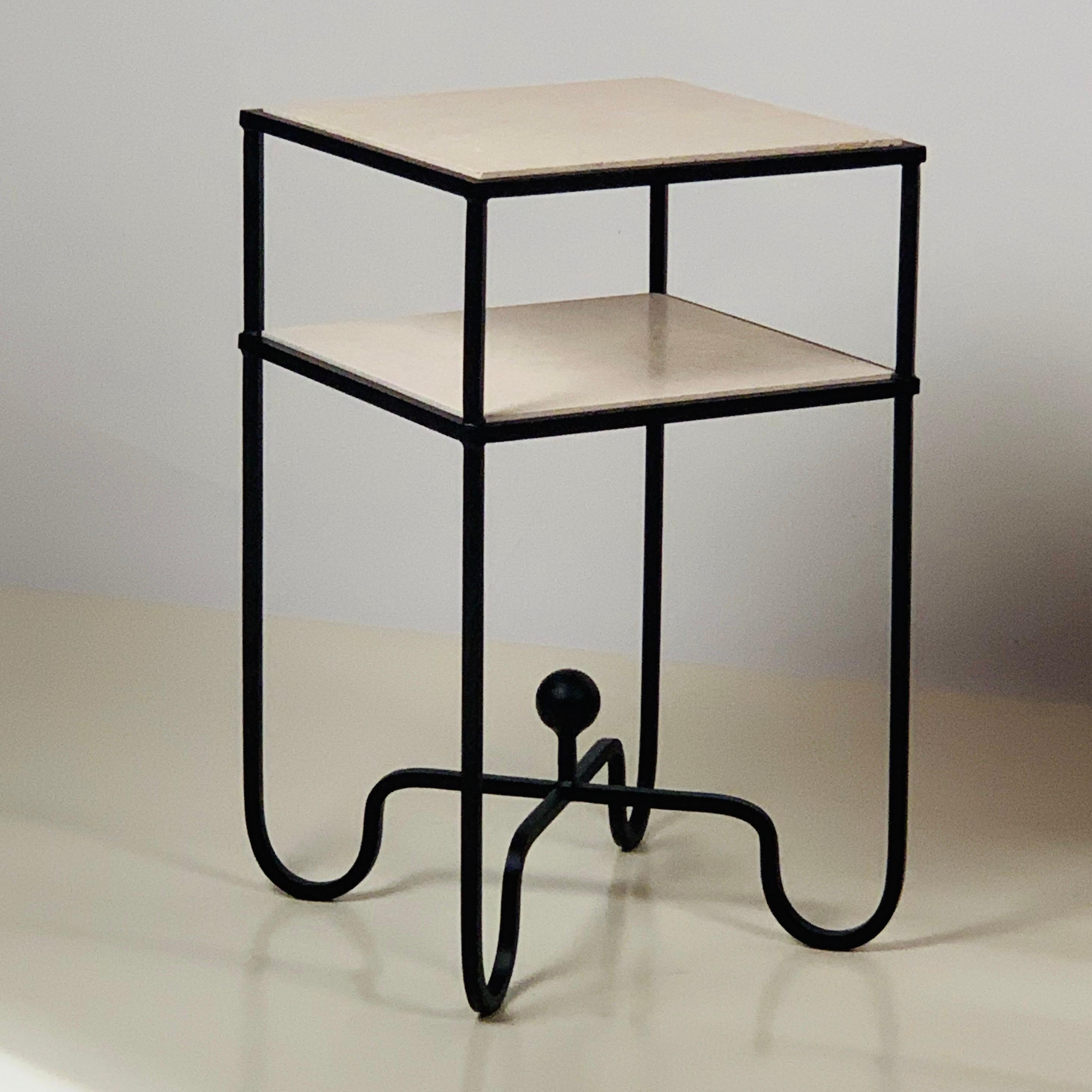 2-tier 'Entretoise' side table by Design Frères. Wrought iron base with 2 thin travertine shelves. Shelves are removable for secure shipping and cleaning.
