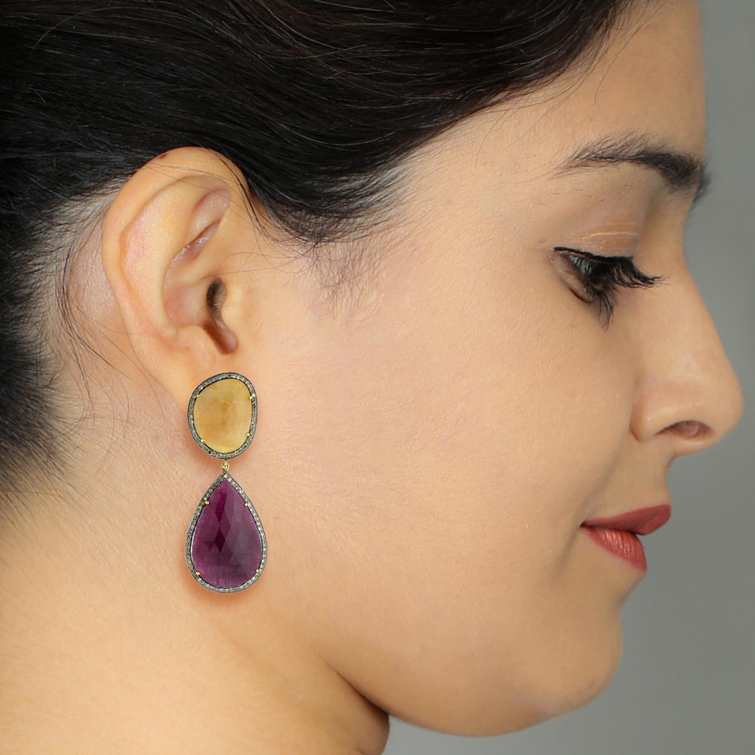 Dangly this 2 tier sliced yellow and pink sapphire earring in silver and gold is a very charming earring with push post

14k: 3.93g
Diamond: 1.38ct
SAPPHIRE: 54.69Cts