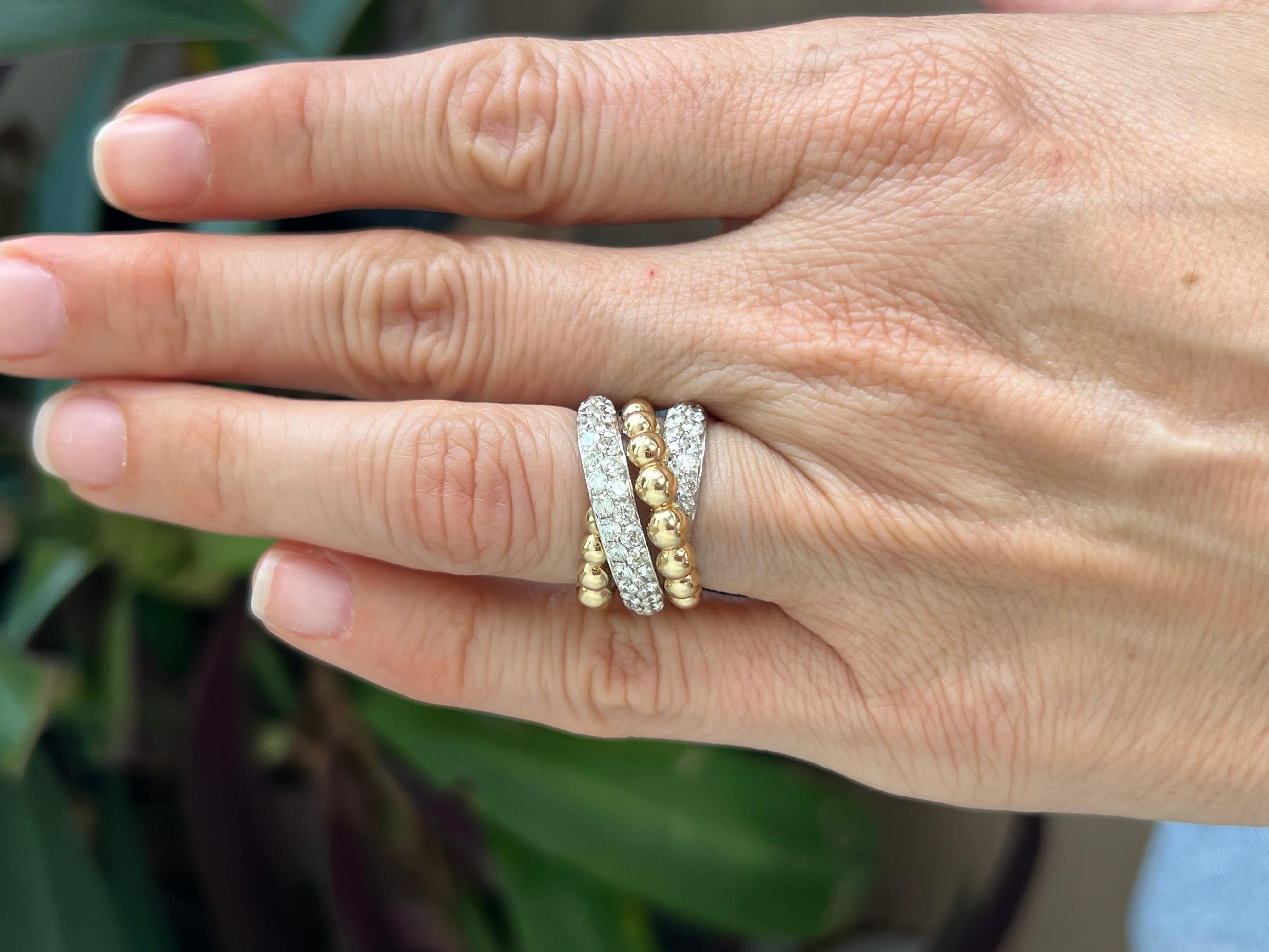 14K white and yellow gold ring with diamond in a multi wrap ring style.

This two tone gold and diamond ring features a classic, timeless design that is versatile enough to be worn for any occasion. Crafted from luxurious 14k gold and premium