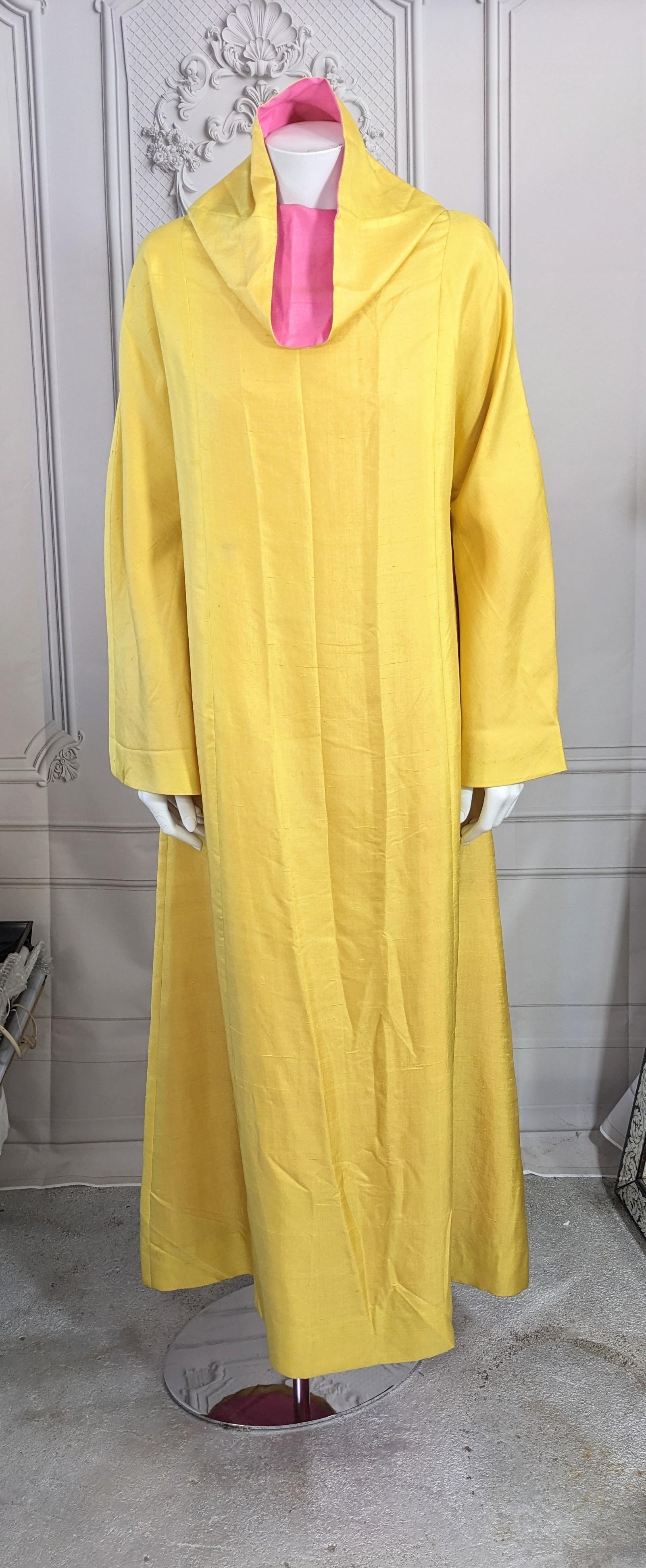 Elegant 2 Toned Caftan in chrome yellow and fuschia raw silk from the 1970's. Cut with identical dress inside so in theory is reversible. Bell sleeves with funnel collar. Slips over head with dramatic A Line cut. 
Custom 1970's. 
