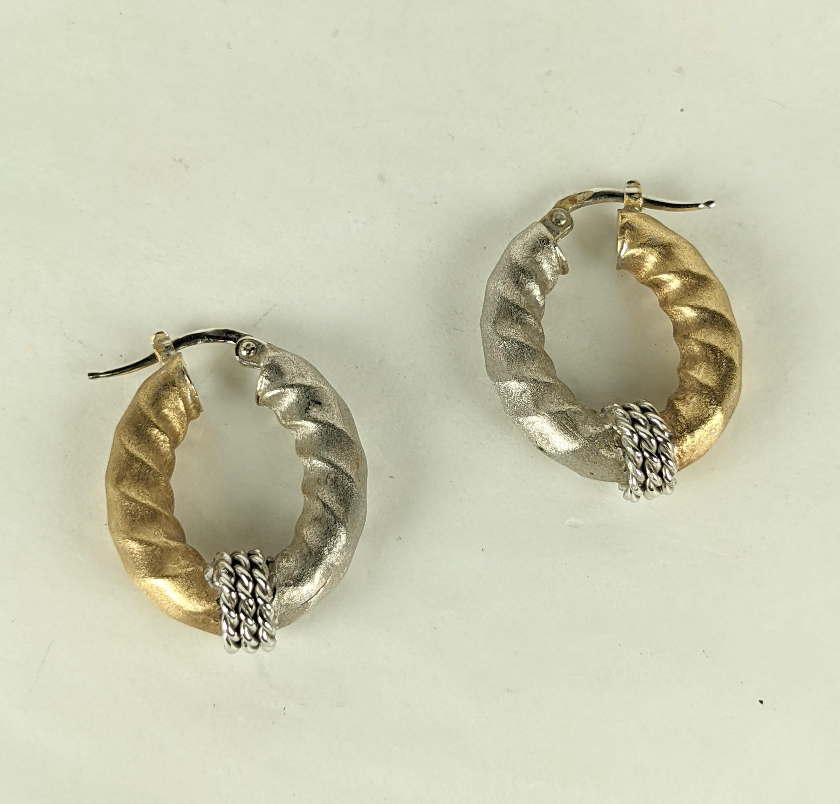 Attractive 2 Toned Satin Finish Gold Hoops in 14k gold with pierced fittings. Twisted hoop design with white and yellow gold in stain finish with chain detailing. 
Marked 14k Italy. 1