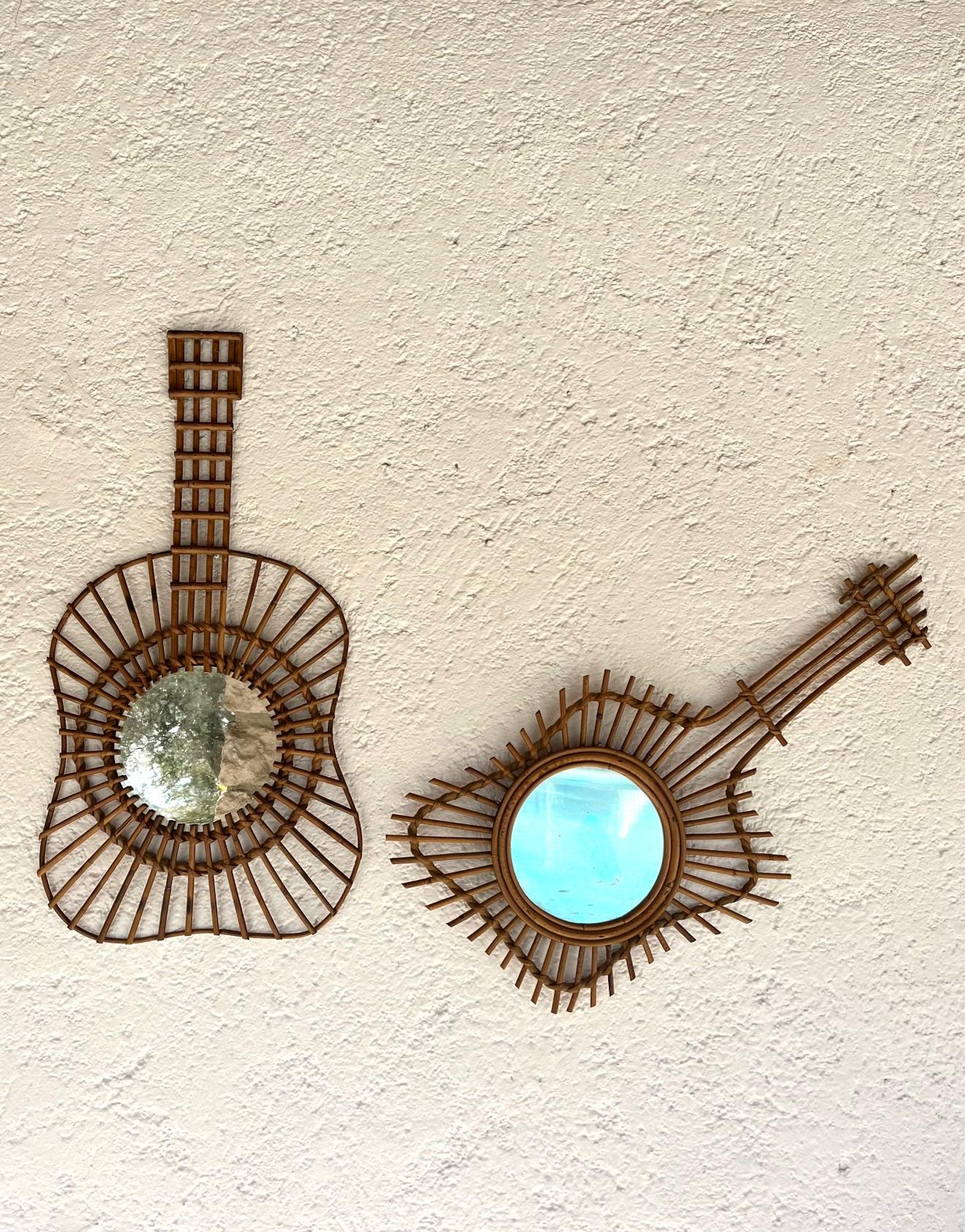 Unusual set of 2  wall mirrors,  France, 1950's. 
The  hand-crafted rattan frames are in the shape of  guitares 
This  highly decorative set of mirrors is evocative of the 