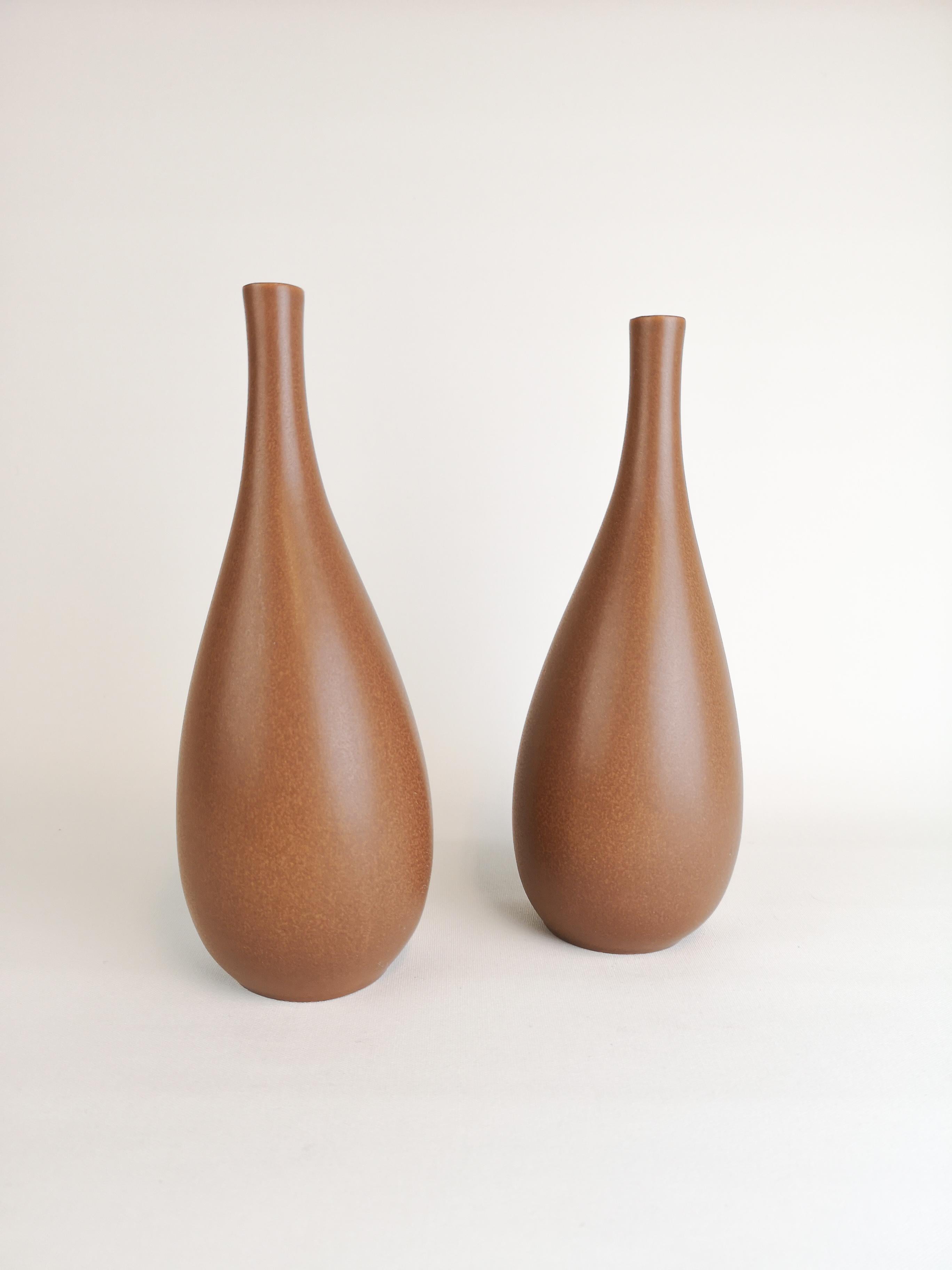 Two nicely shaped vases produced in Sweden and Gustavsberg. The designer Stig Lindberg is excellent in the way he has made the forms of the vases. Stig Lindberg's striking vase with swelling form and semi-matte brown glaze. Elegant midcentury