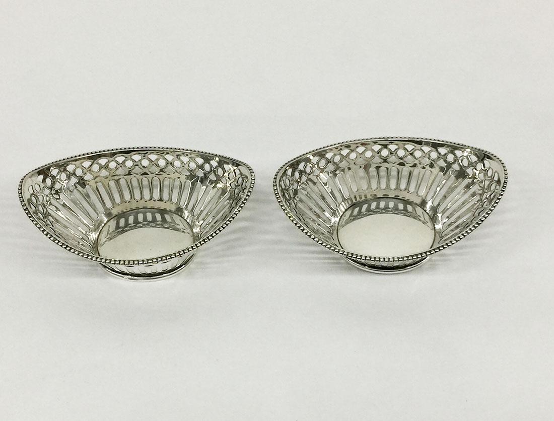 2 very small Dutch silver bonbon baskets 

A tight boat-shaped small baskets with a fine pearl border
The Dutch silver hall marks are as follow:
Master sign of Schriek.H, Schoonhoven (1967-1989)
Walking lion II
Minerva head M (Schoonhoven)
Year