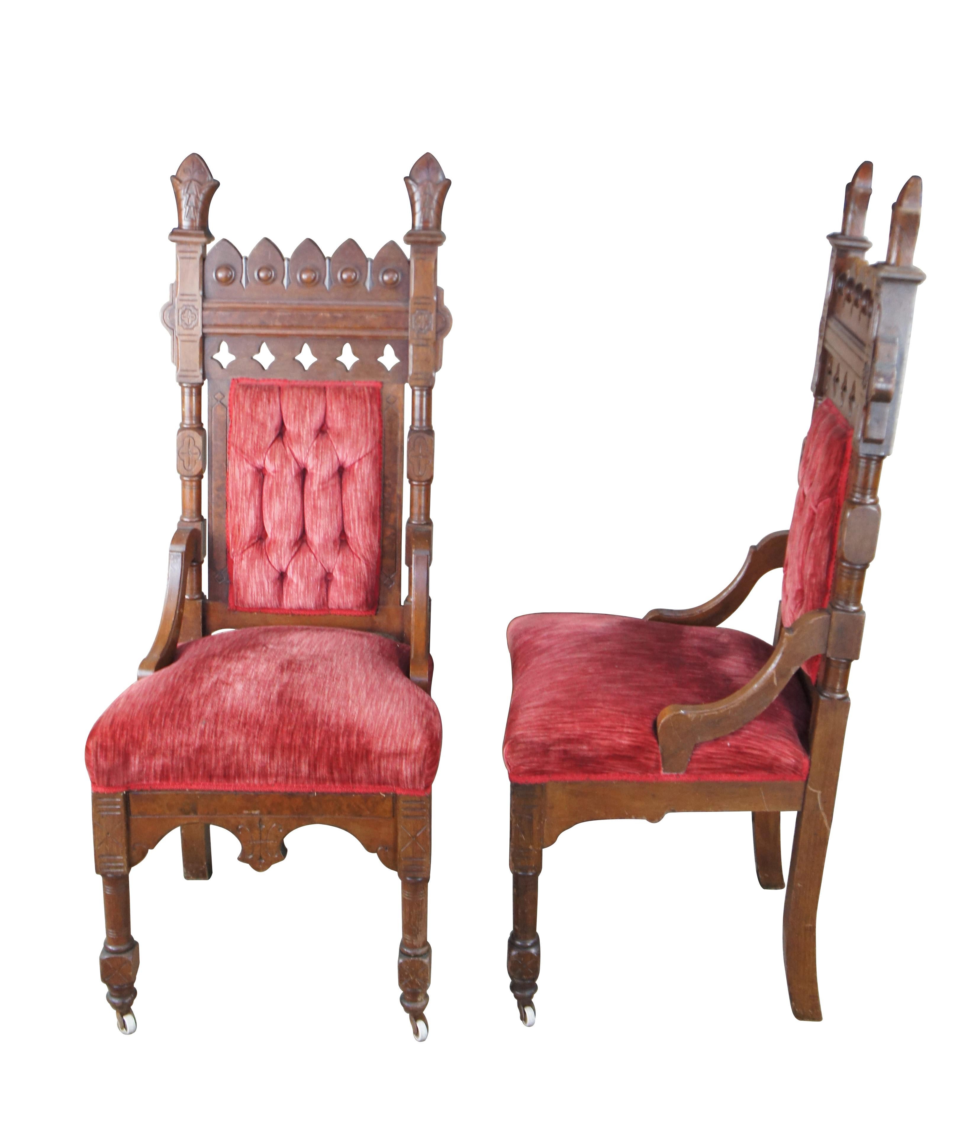 Pair of antique Victorian Gothic Style highback throne chairs.  Features a walnut frame with pierced and carved back, upholstered in a red velour with tufted back.  The chair is accented by walnut burl panels and topped by Mitre hat carved finials. 