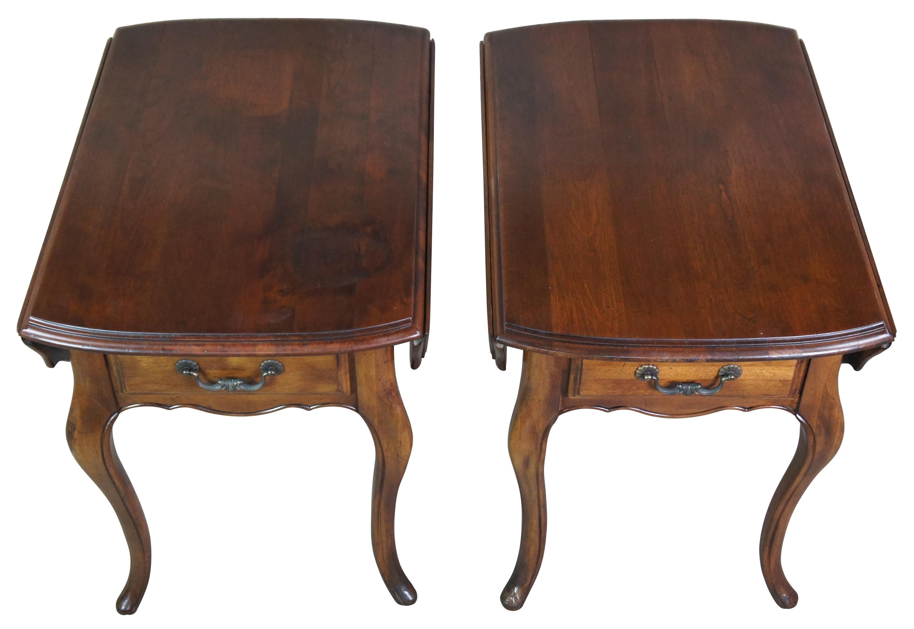 Pair of two vintage 1986 Ethan Allen French Country oval drop leaf side tables featuring serpentine form with one drawer. Made from Maple & Birch

Measures: 19.5