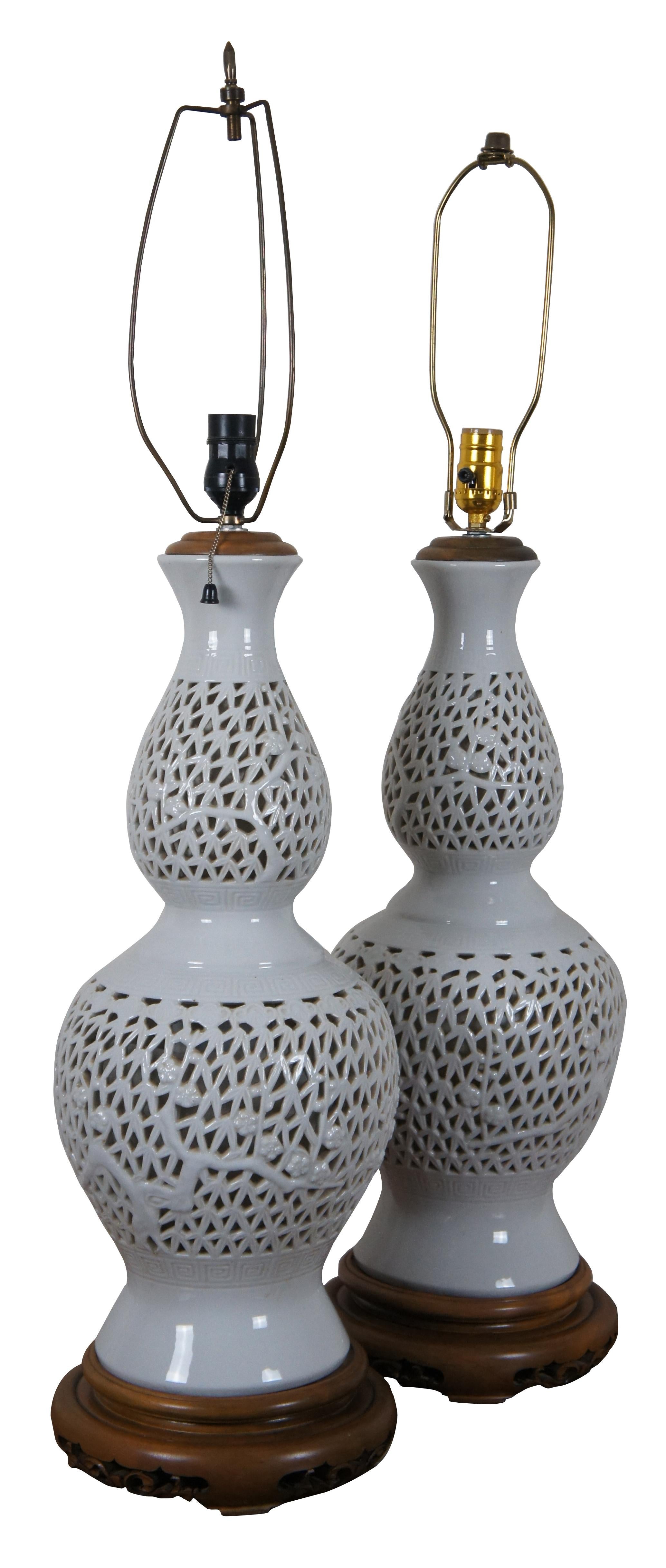 Pair of mid-century blanc de chine reticulated porcelain table lamps with wood base and cap, featuring a gourd shaped form pierced with a design of bamboo stalks and leaves.

Measures: 9.5” x 28” / approx total height – 37” (diameter x height).
