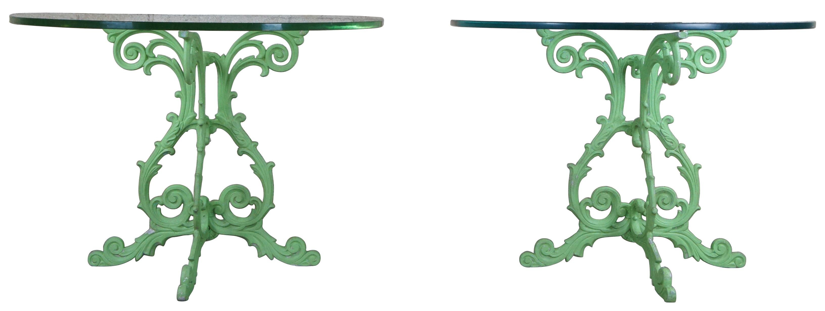 2 mid century cast iron and glass demilune console tables. Featuring scrolled iron bases and heavy glass tops. Bases finished in a lime green. 

Measure: Base - 26.5