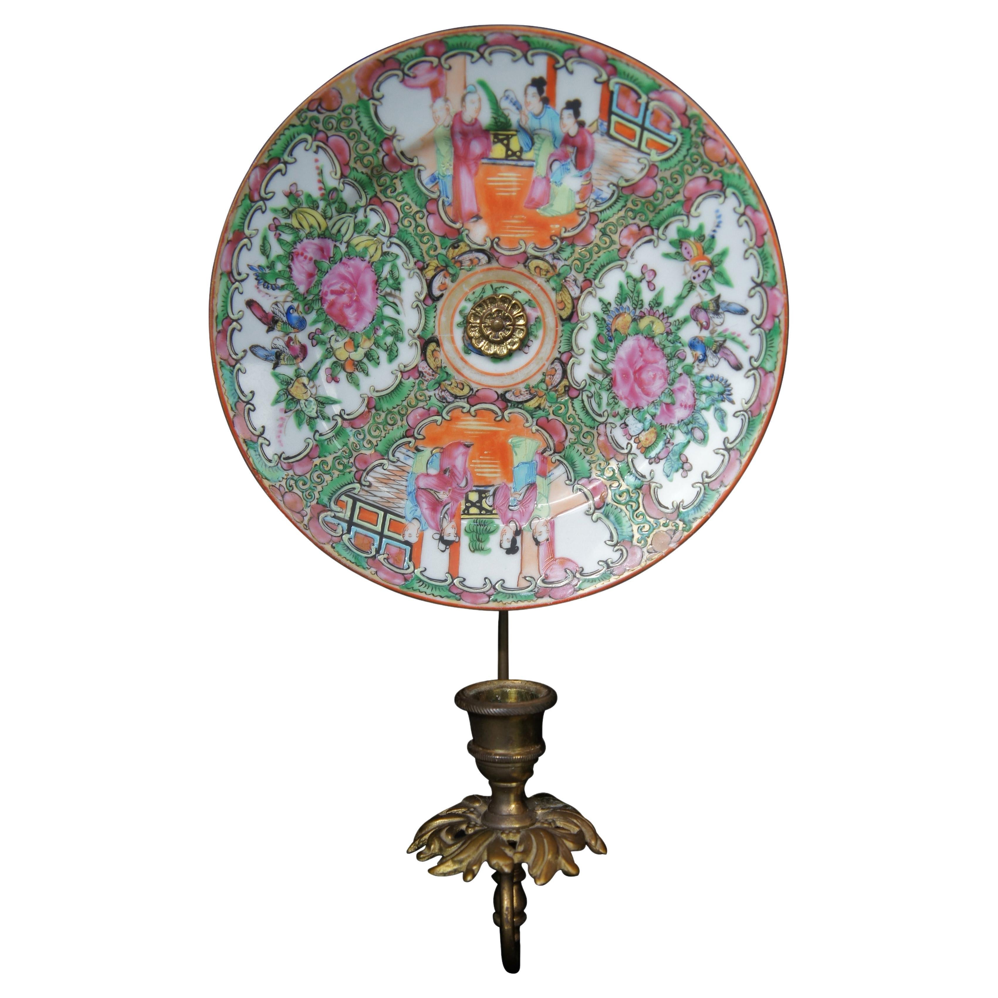 A lovely pair of brass wall hanging candle sconces with hand hand painted famille rose medallion salad plates. features flowers and geisha scenes. Each sconce holds one candle and has a floral drip pan. 
 