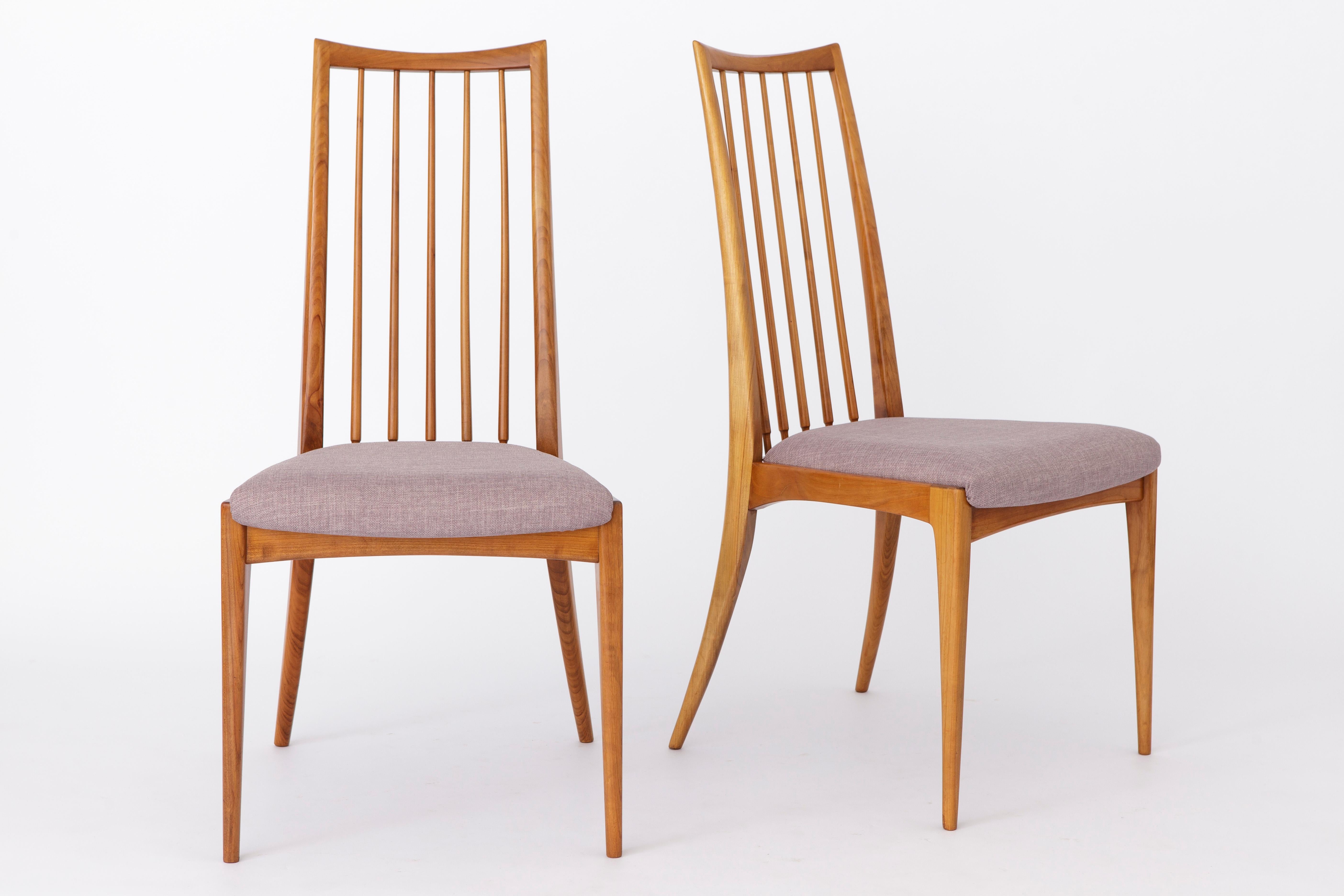 Pair of vintage chairs from German Origin. 
Dedicated designer: Ernst Martin Dettinger
Production period: approx. 1960s. 

Sturdy wooden frames. Refurbished and oiled. 
Wood sort most likely pear or cherry wood. 
Seats reupholstered with purple