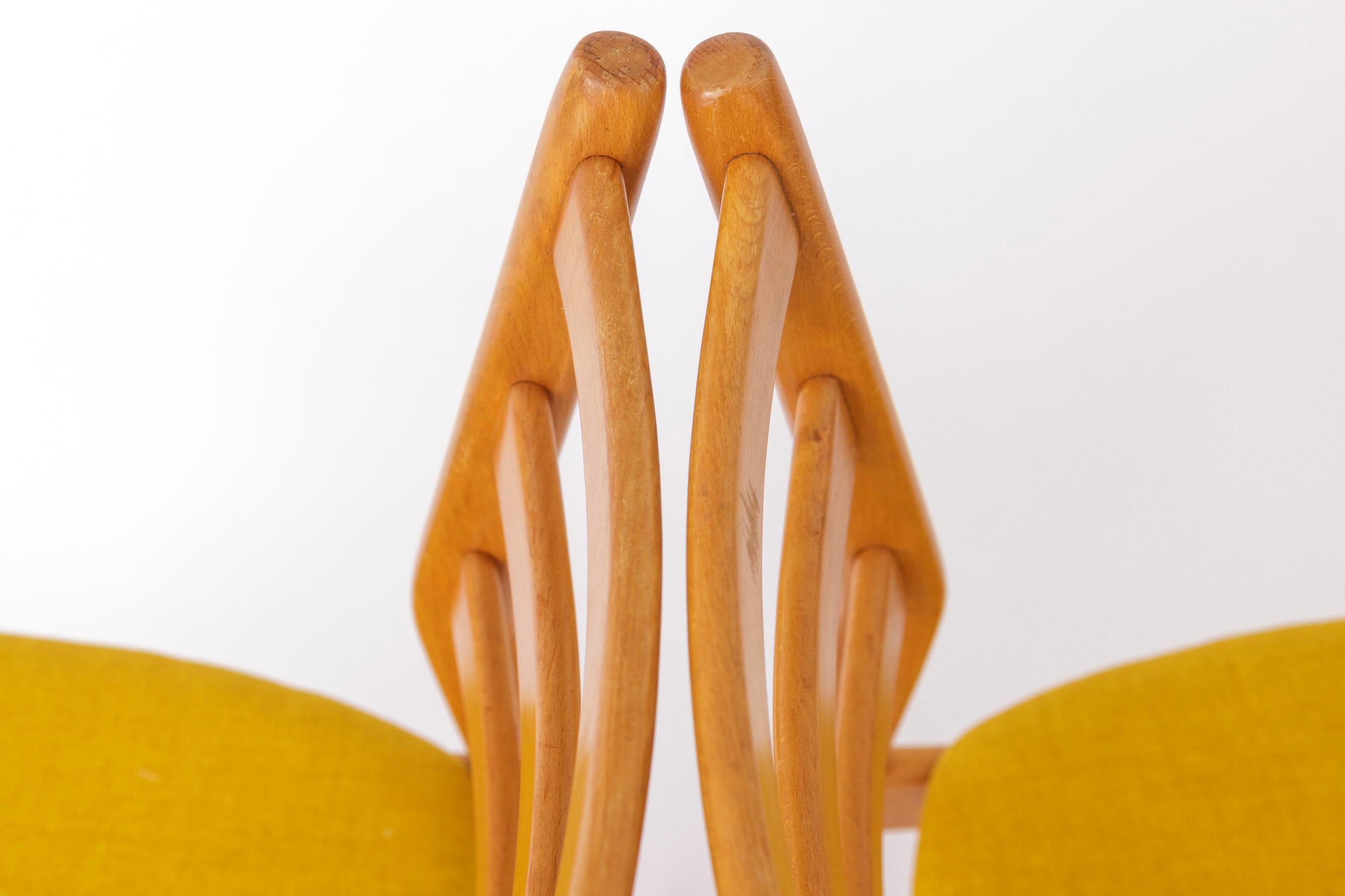 Pair of Vintage dining chairs by German manufacturer Casala. 
Production period: 1970s. 
Displayed price is for a pair. 

Sturdy beech wood frame. Refurbished and oiled. 
Reupholstered with yellow textile. 
Manufacturer's plate under the seat.