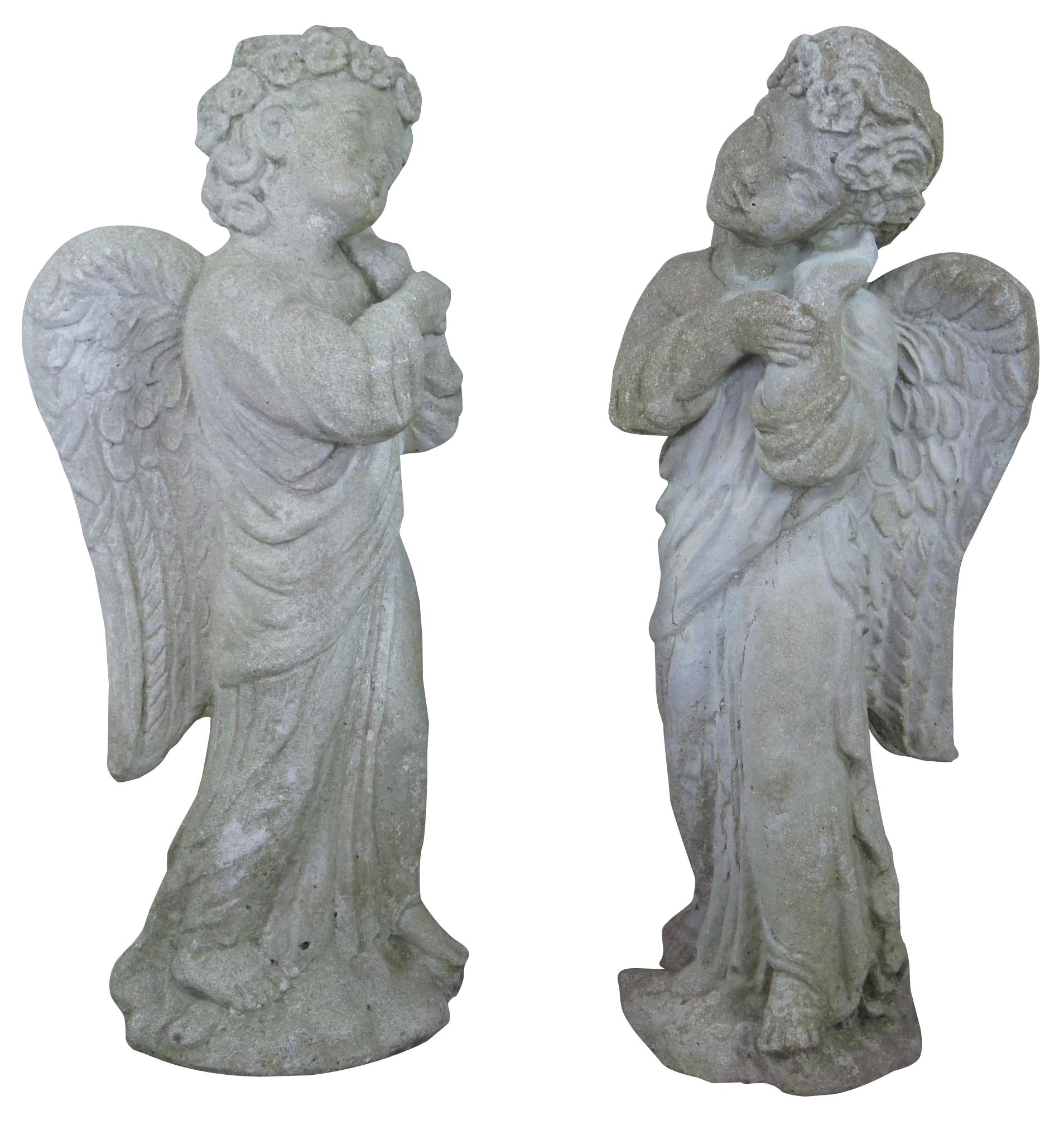Circa 1980s concrete angel statues. Features a winged cherub pleasantly resting its head on hand with floral tiara. 

88 lb each.