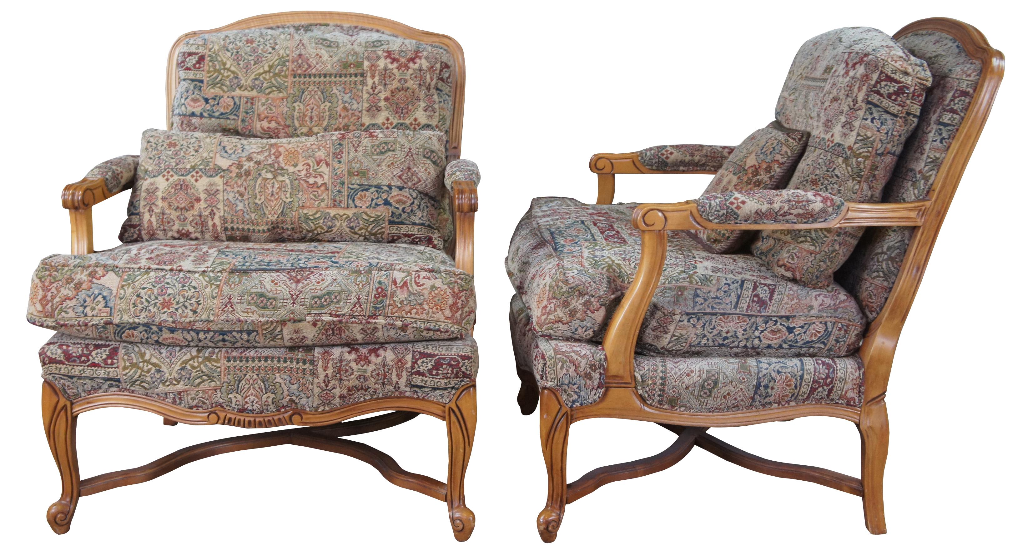 Pair of two vintage French Provincial arm chairs and ottoman. Features fauteuil style exposed wood frame with padded arms, cabriole feet and X stretcher.

Measures: Chair - 30