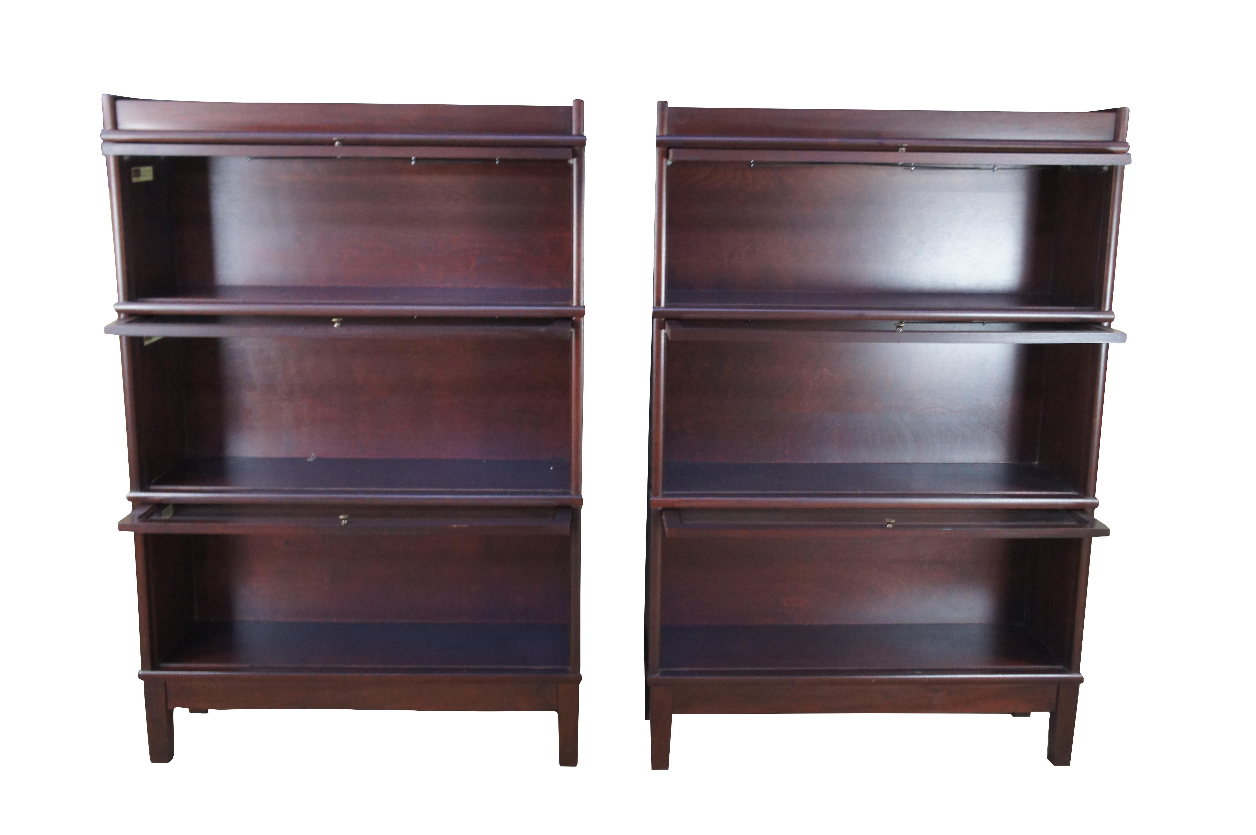 Pair of Late 20th Century Hale Industries Barrister Lawyer Stacking Bookcases.  Classic Mission styling. Made from walnut with #168 mahogany finish.  Features three glass display sections with brass handles.  

Dimensions:
51.5