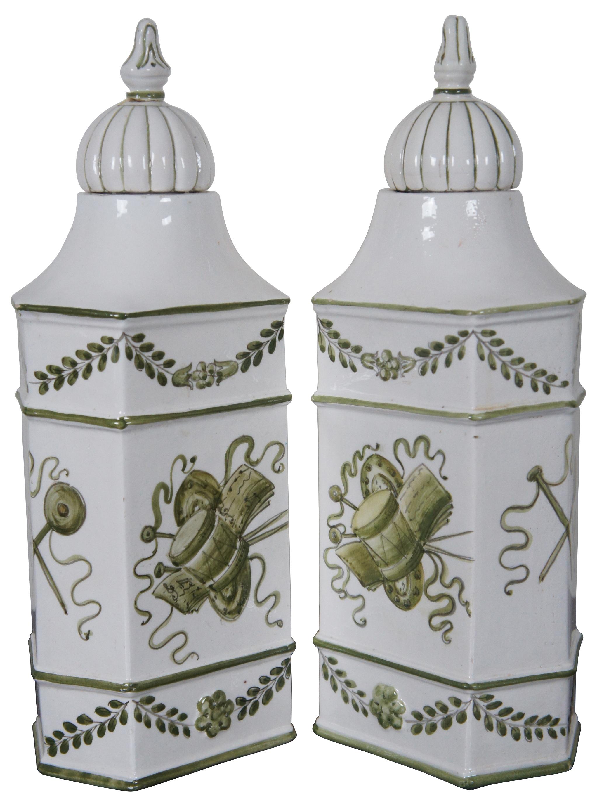 Pair of vintage Italian porcelain hand painted lidded vases with green floral and musical instrument motifs. Measure: 15