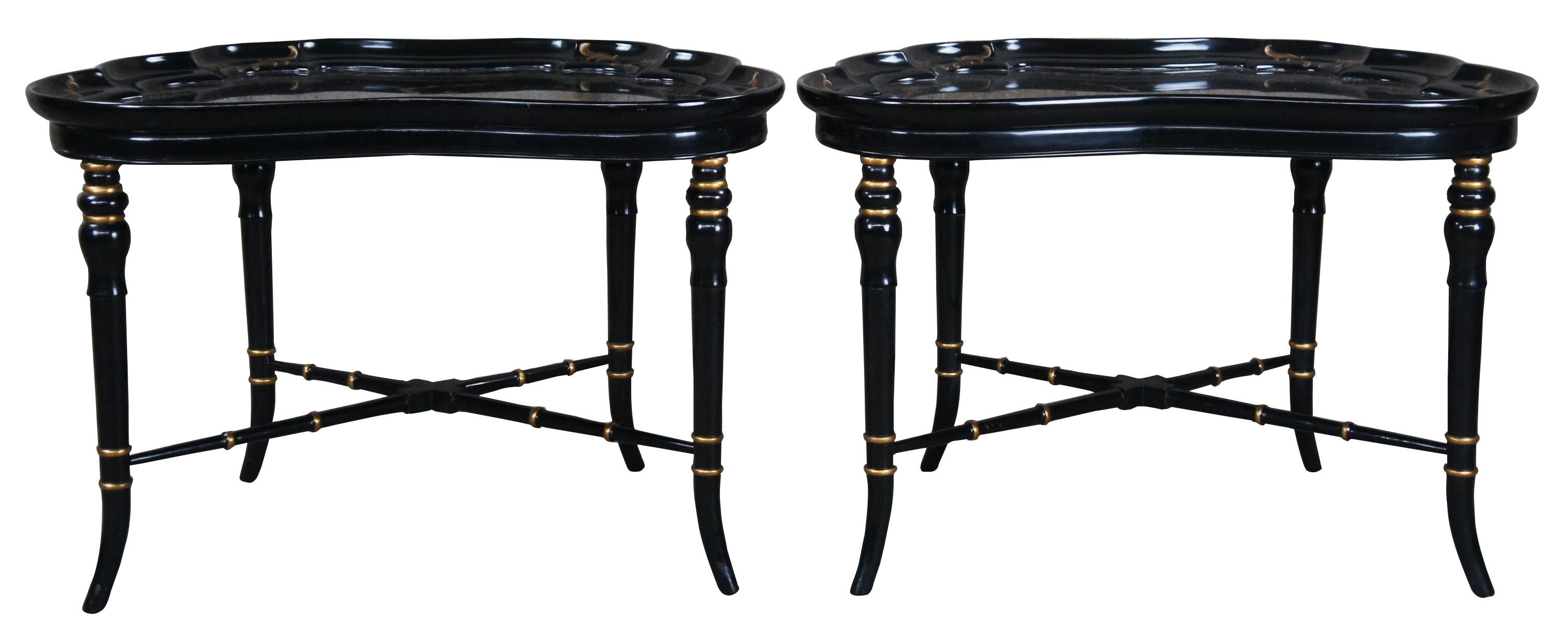 Two vintage English Regency style tray tables by Karges Furniture.  Featuring black lacquered finish with a butterfly shaped top with gallery that surrounds a scene of two gamecocks and a old Bonsai tree.  Supported by faux bamboo legs with gold