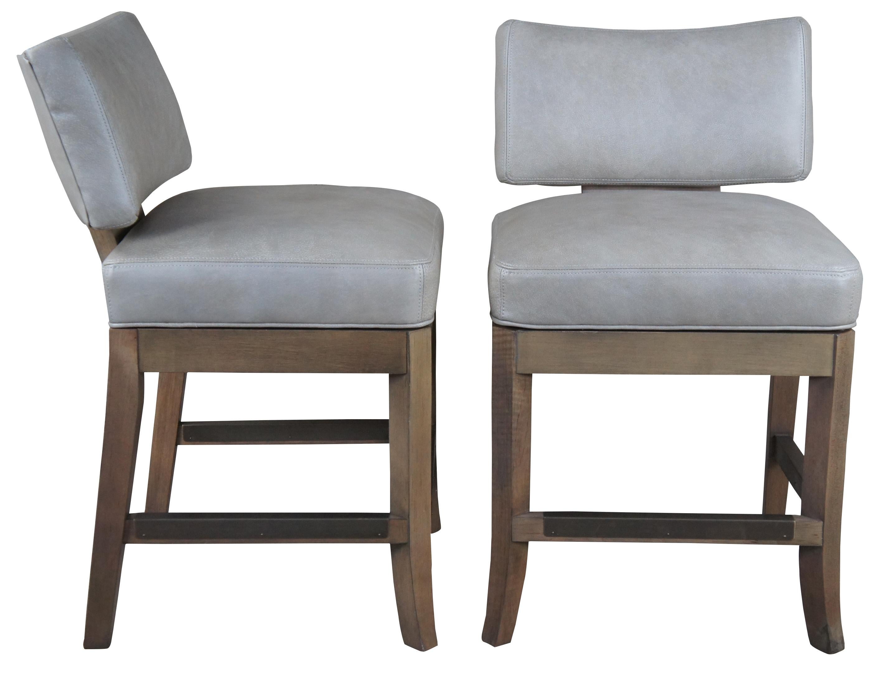 Two vintage McKinley of Hickory Inc Barstools featuring gray bovine leather upholstery with swivel action and metal foot guards.

The McDowell swivel barstool is a handsome addition to any decor. Suitable in a contract, hospitality or residential