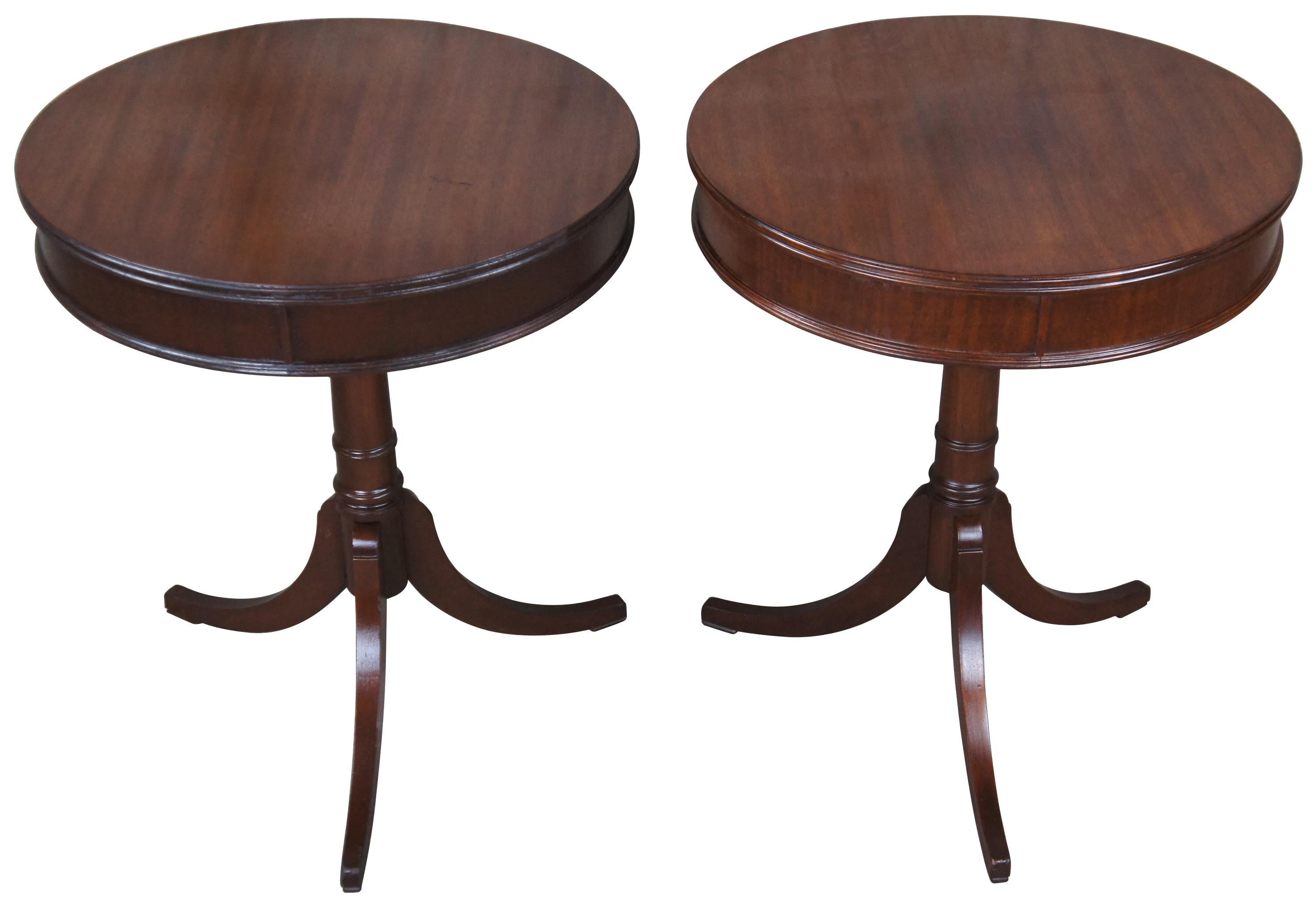 2 beautiful Duncan Phyfe style accent tables, circa mid 20th century. A round form made from mahogany with a graduated base terminating into 3 saber legs.
 