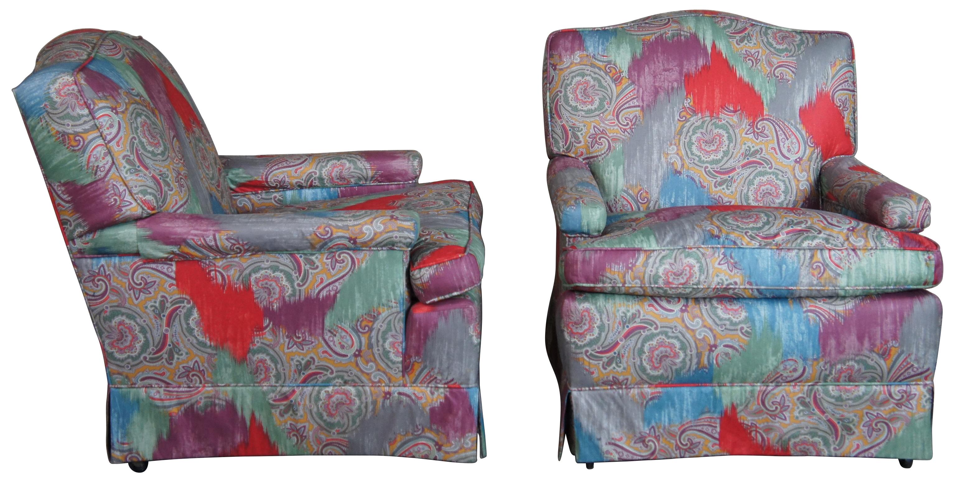 Two vintage mid century arm chairs. Featuring a camelback, modern paisley fabric with walnut legs and castors.
 