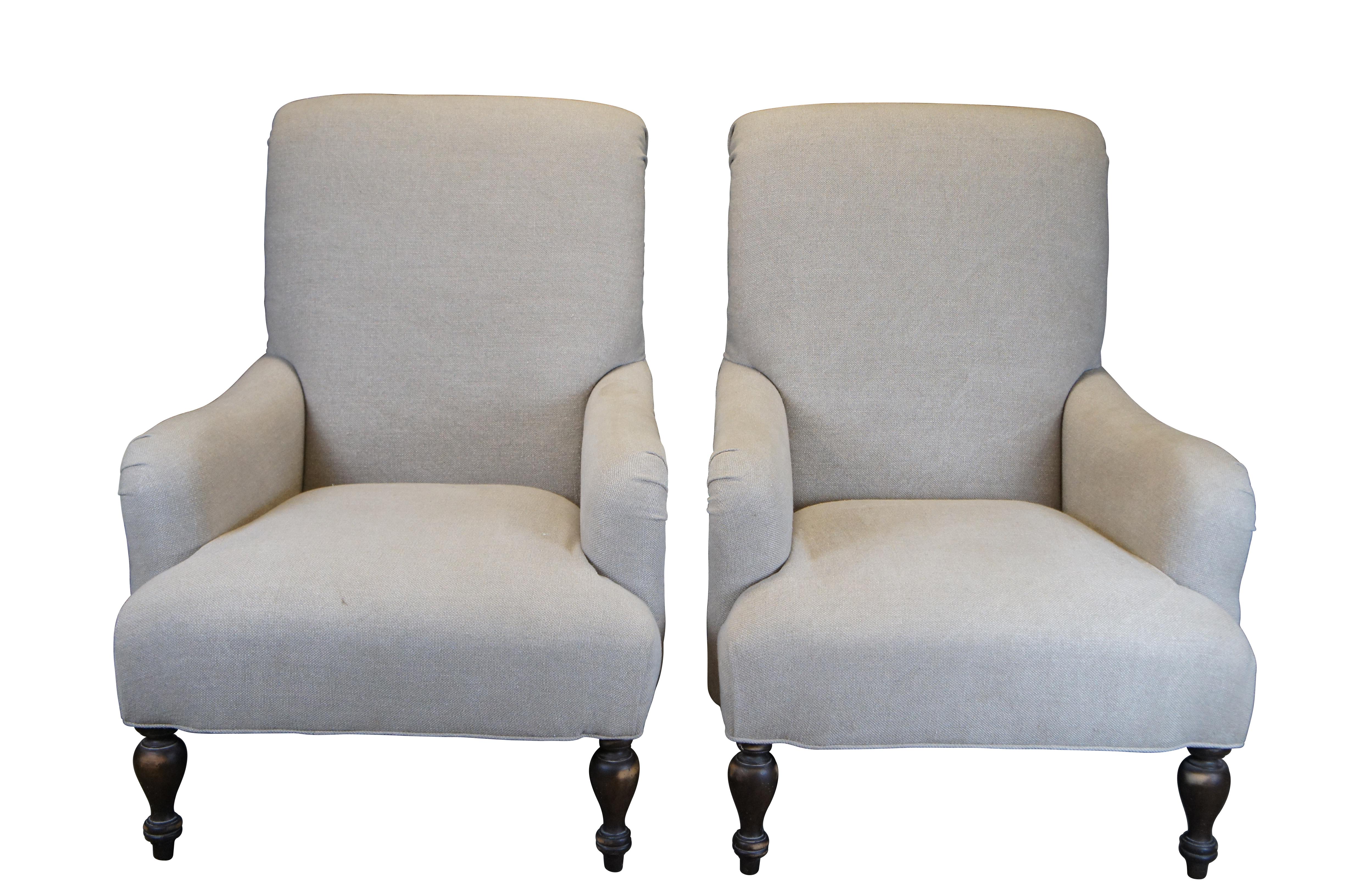 Pair of two vintage Paul Robert Quinn 7010 arm chairs featuring linen fabric with rolled back and padded arms over turned legs.  

Paul Robert Inc was established in 1983 by Paul Robert Dickinson. After 30 years in the furniture business, he pursued