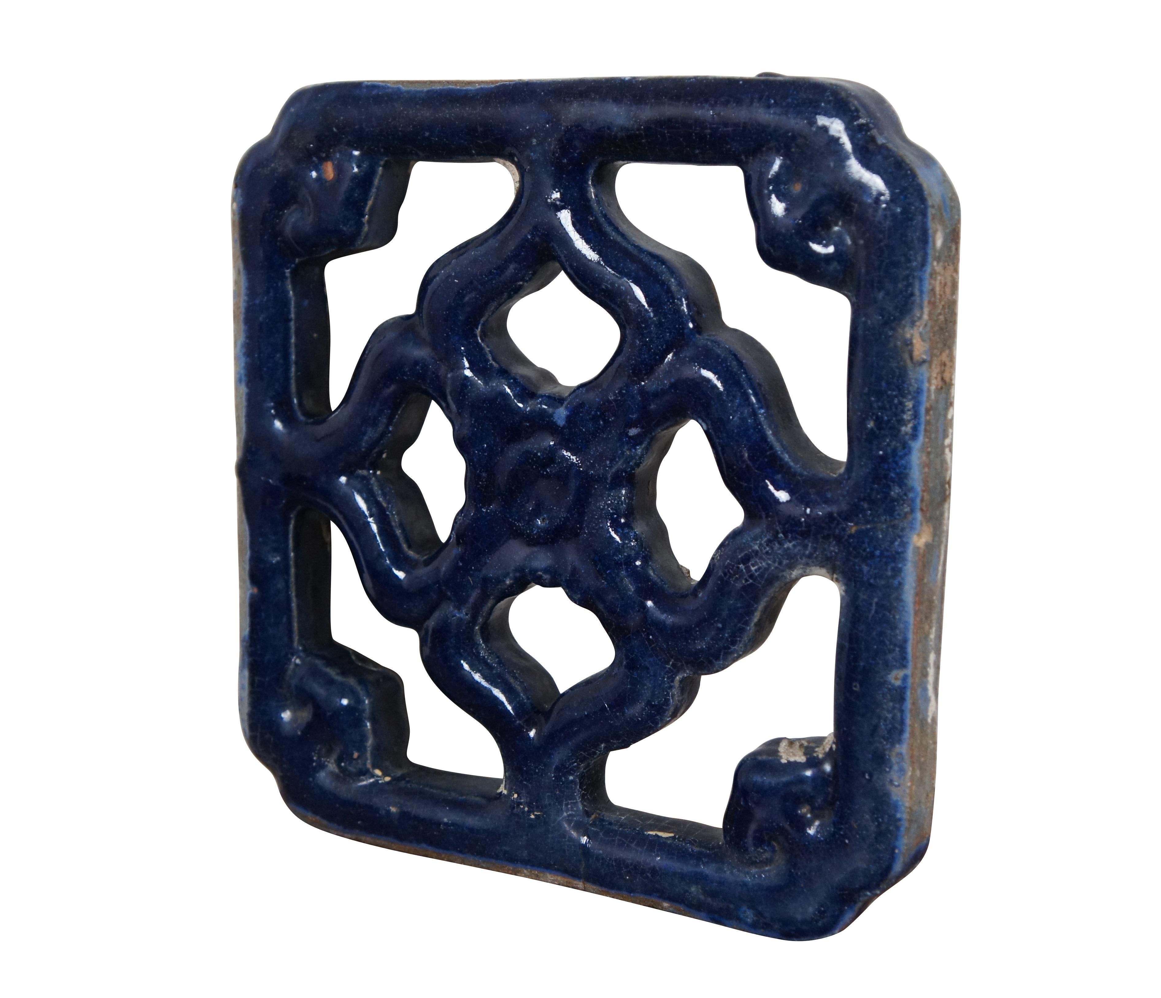 Pair of vintage pierced floral ceramic blue glazed vent / grille tiles.  

Dimensions:
10.25
