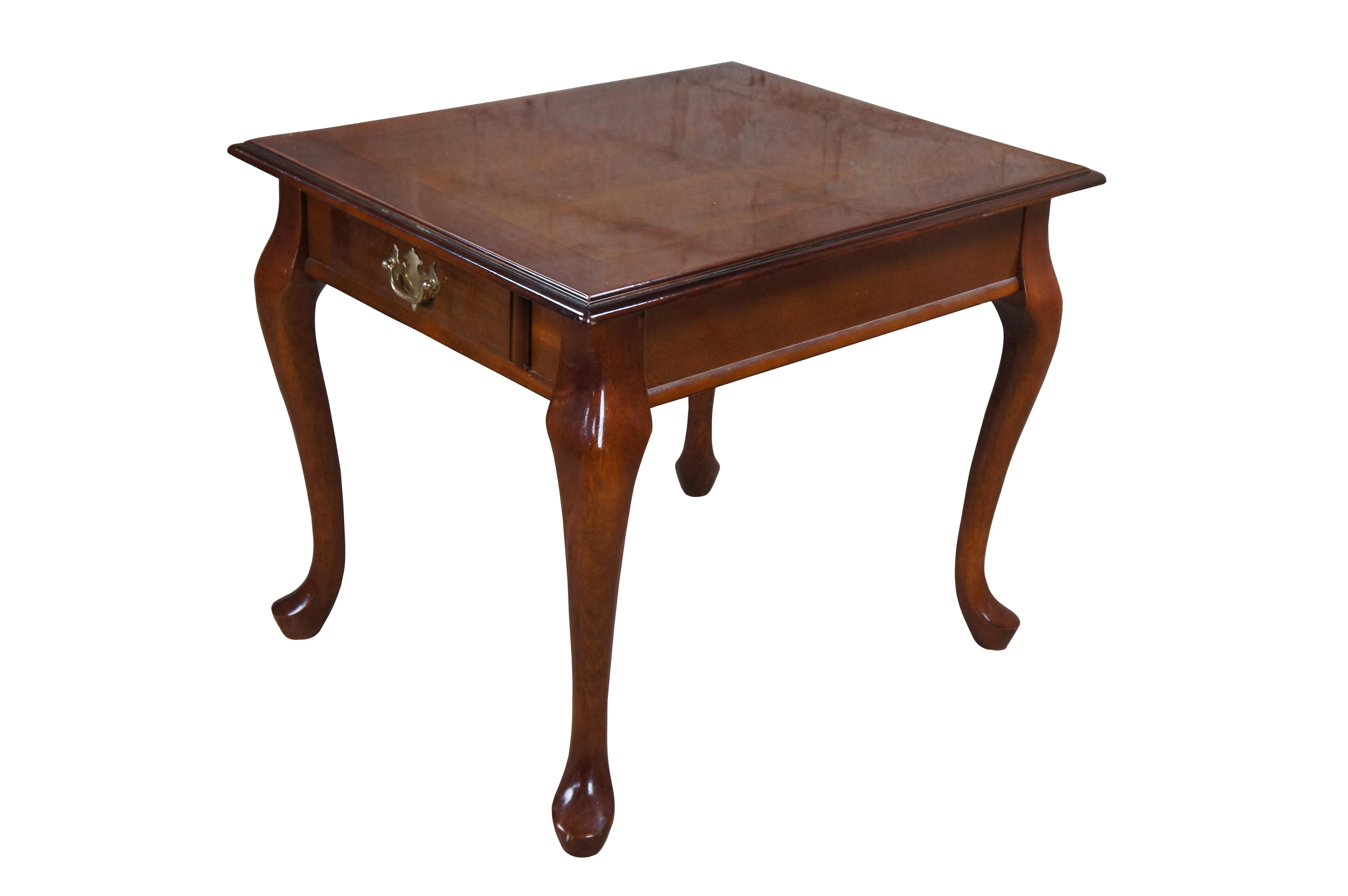 Vintage Queen Anne style side tables featuring rectangular form with serpentine legs, pad feet and one drawer with federal / colonial brass hardware.

Dimensions:

26