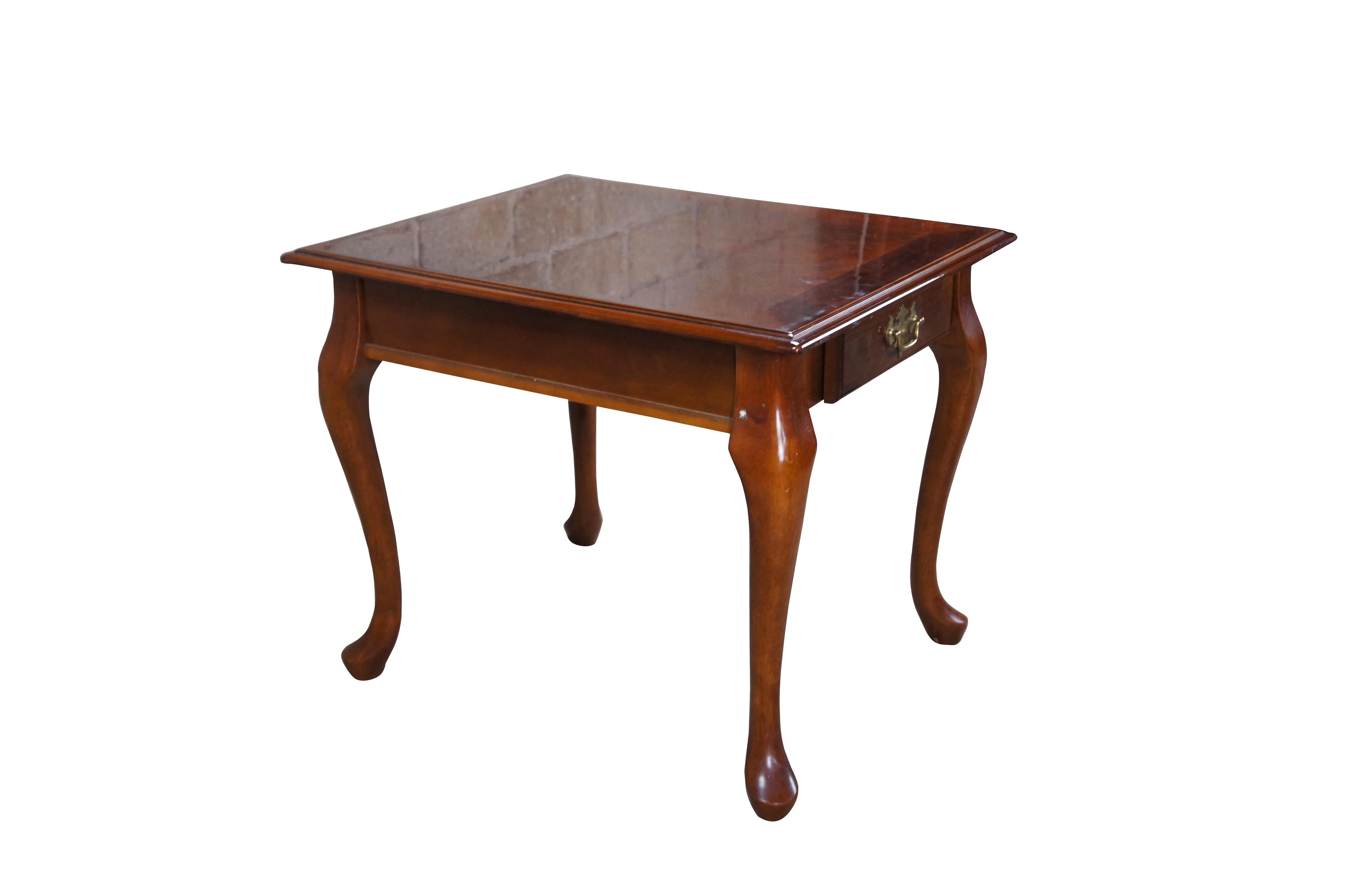 Vintage Queen Anne style side tables featuring rectangular form with serpentine legs, pad feet and one drawer with federal / colonial brass hardware.

Dimensions:
26