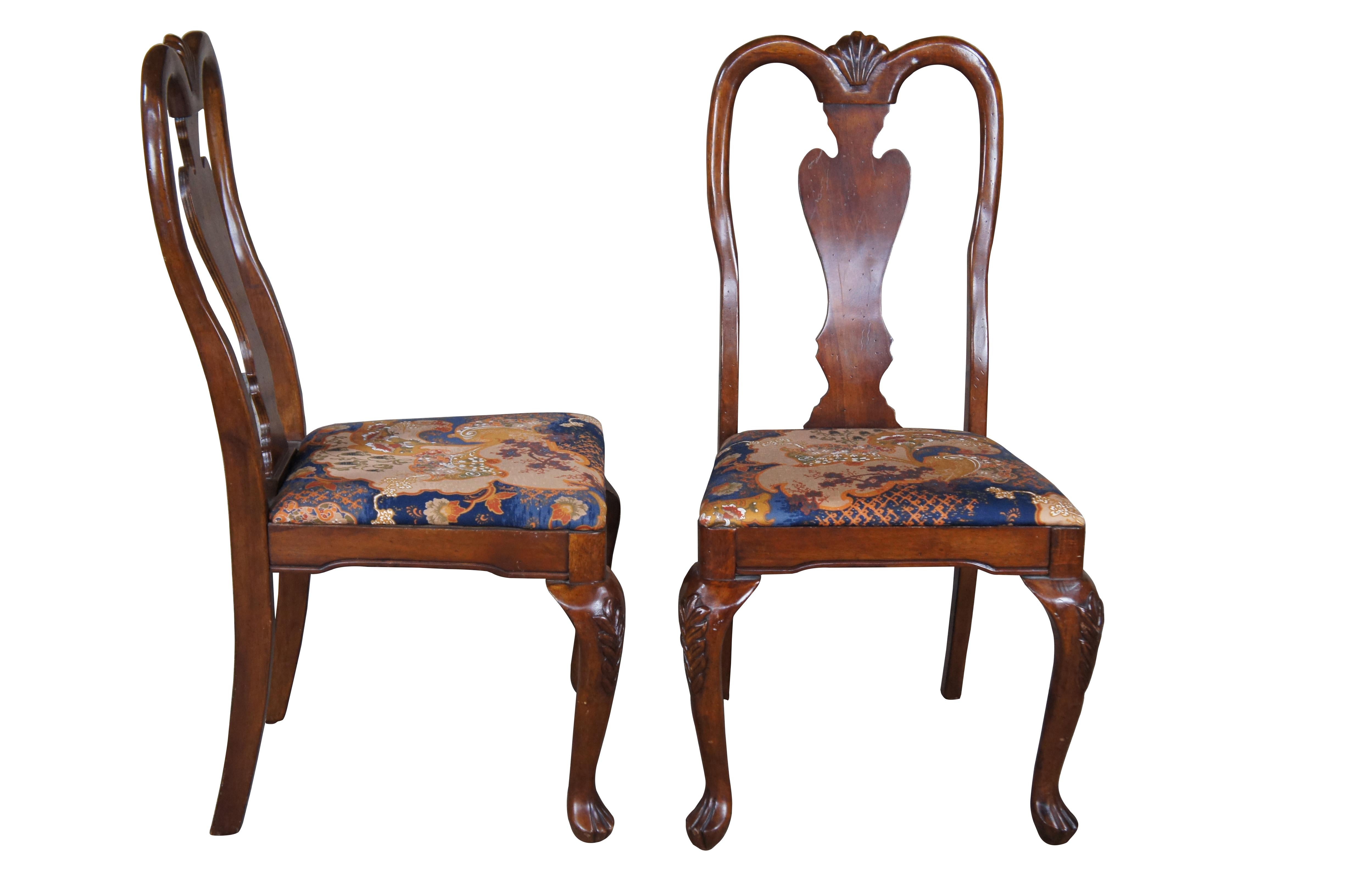 Pair of late 20th Century mahogany finish Queen Anne style side chairs.  Features a contoured crest rail over vase shaped splat leading to a silk chinoiserie seat and cabriole legs.  

Dimensions:
21