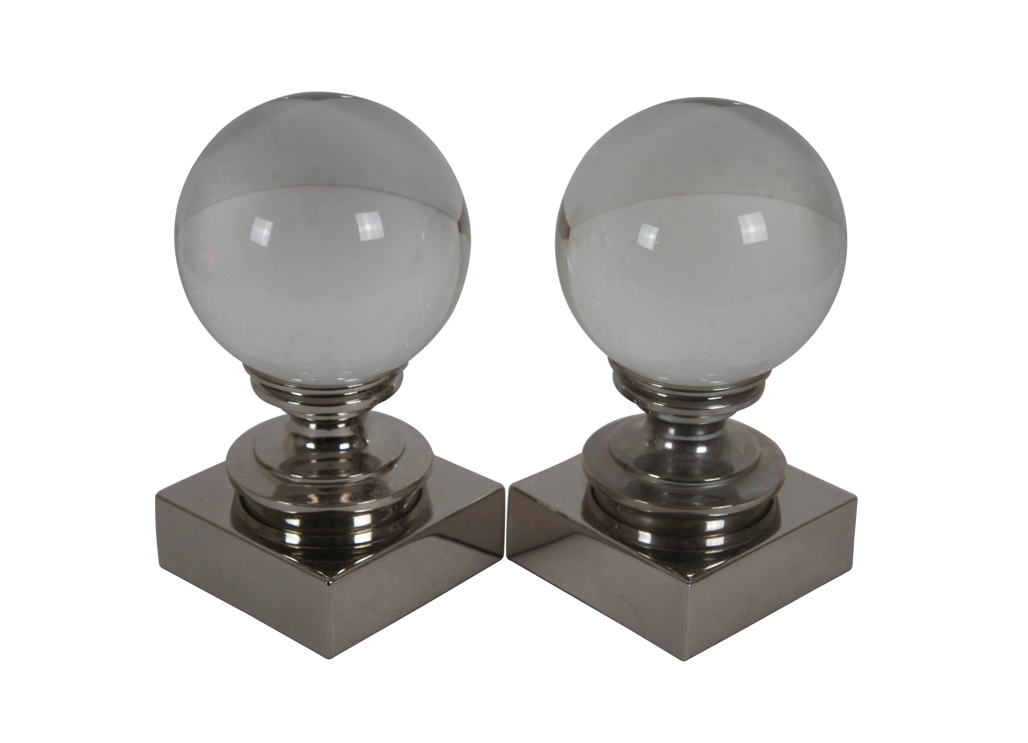 Pair of Restoration Hardware bookends / paperweights, featuring a clear crystal ball perched on a chrome finished turned pedestal. 

Dimensions:
3.5