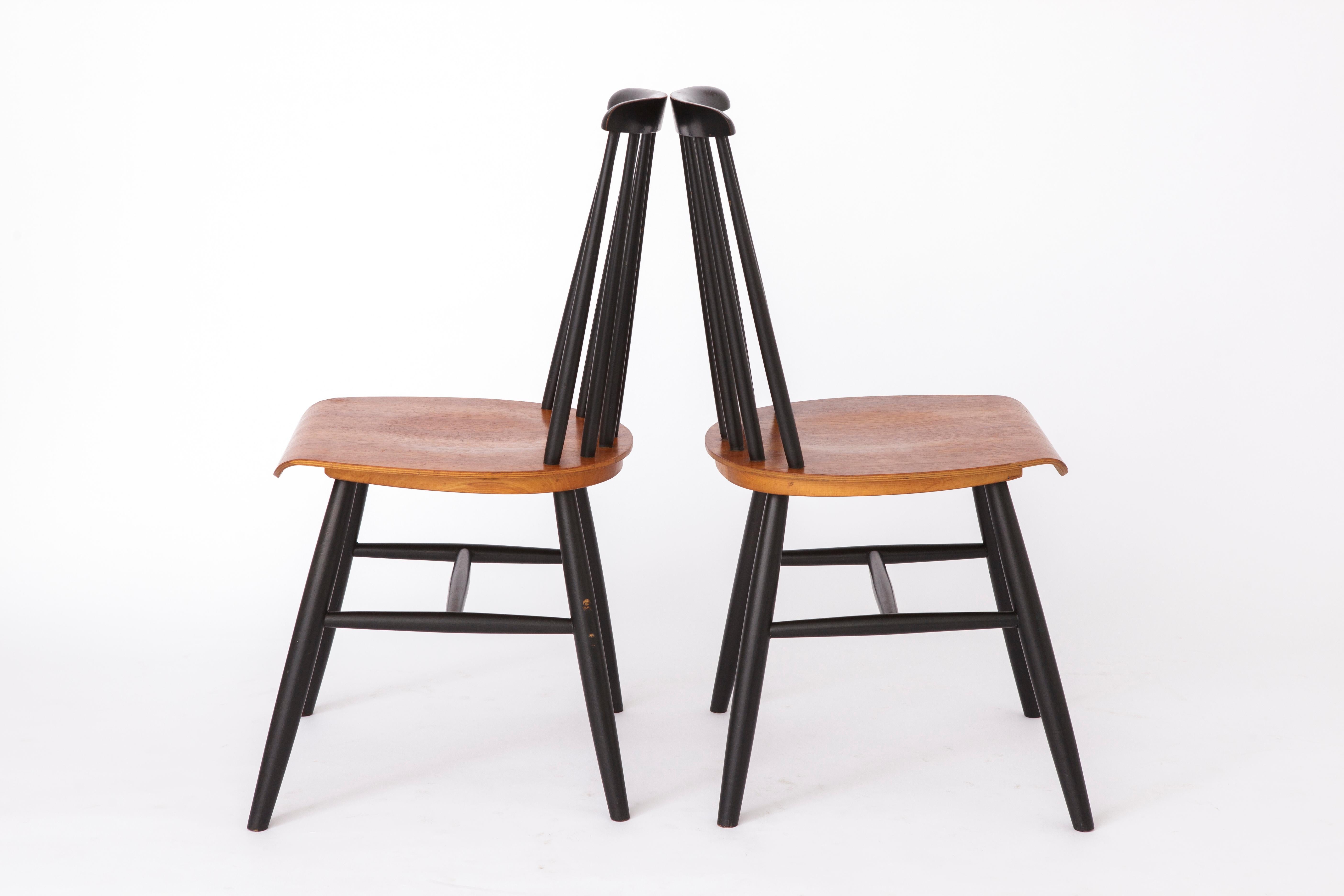 Pair of midcentury chairs, most likely from the manufacturer Nesto, Sweden. 
Production period: 1960s-1970s. 
Displayed price is for a pair. 

Good, stable condition. Teak wood seat and black lacquered birch wood frame. 
No cracks or repairs in the
