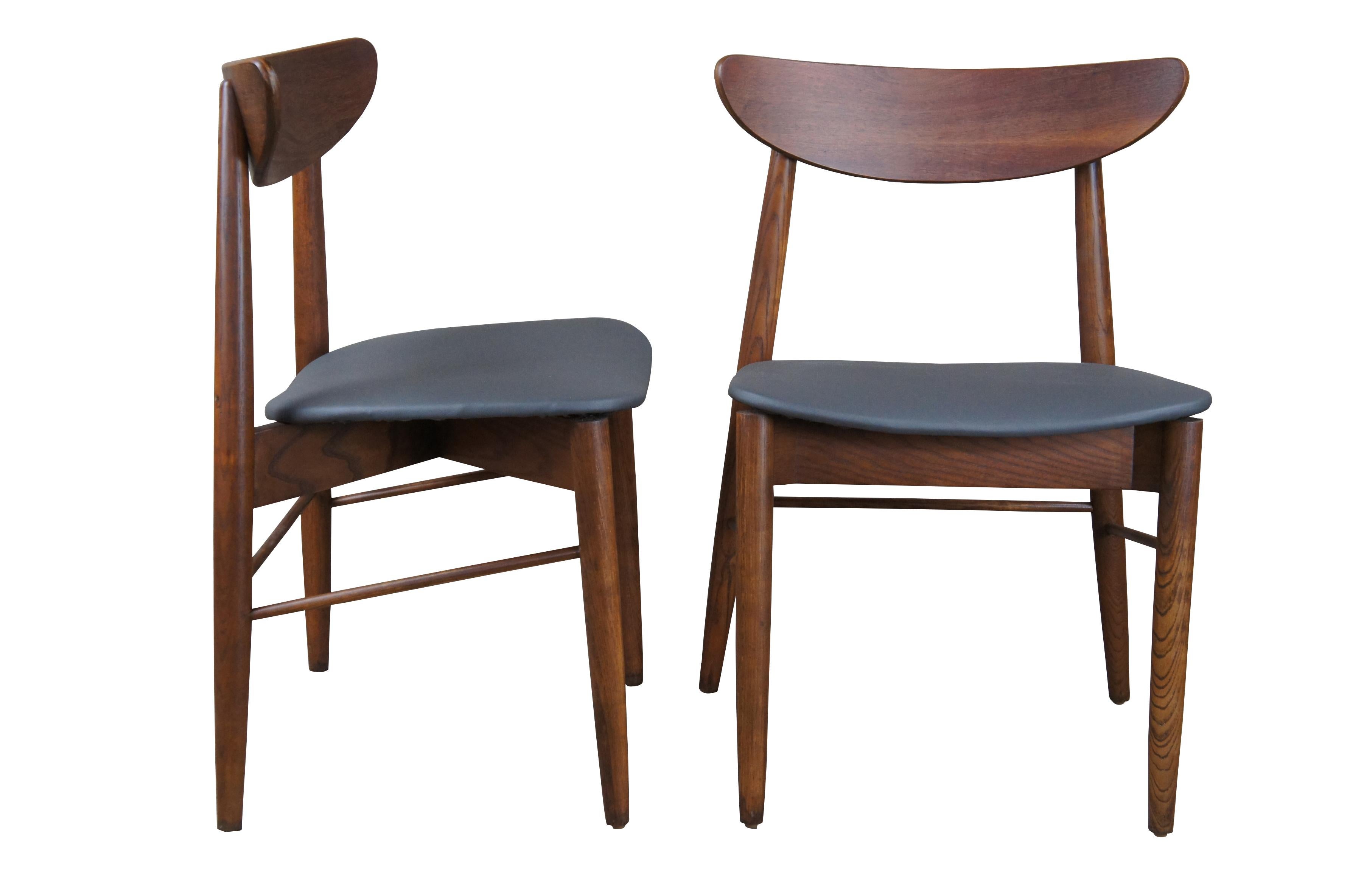 Stanley Mid-Century Modern side chairs, Circa 1960s. Made from walnut with a Danish or Scandinavian inspired design. Features a curved back and vinyl seat. Marked side chair 385.
