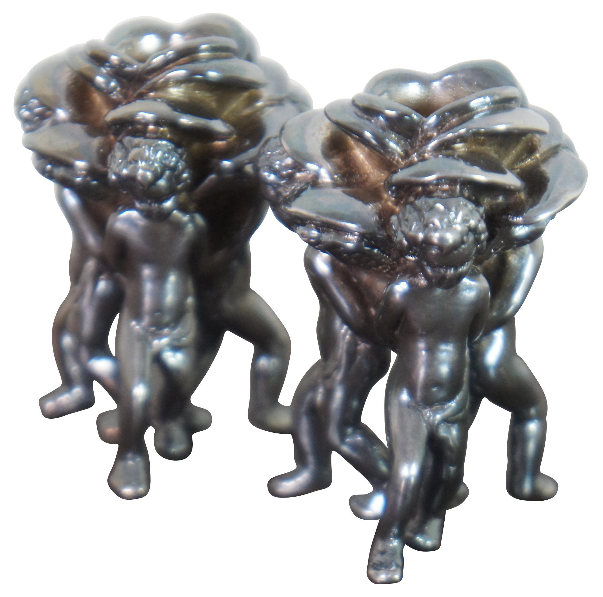 Pair of vintage 925 sterling silver taper candle holders featuring three cherubs holding a rose.

Measures: 1.75” x 1.5” x 2.375” / 33.8 g (Width x Depth x Height).
