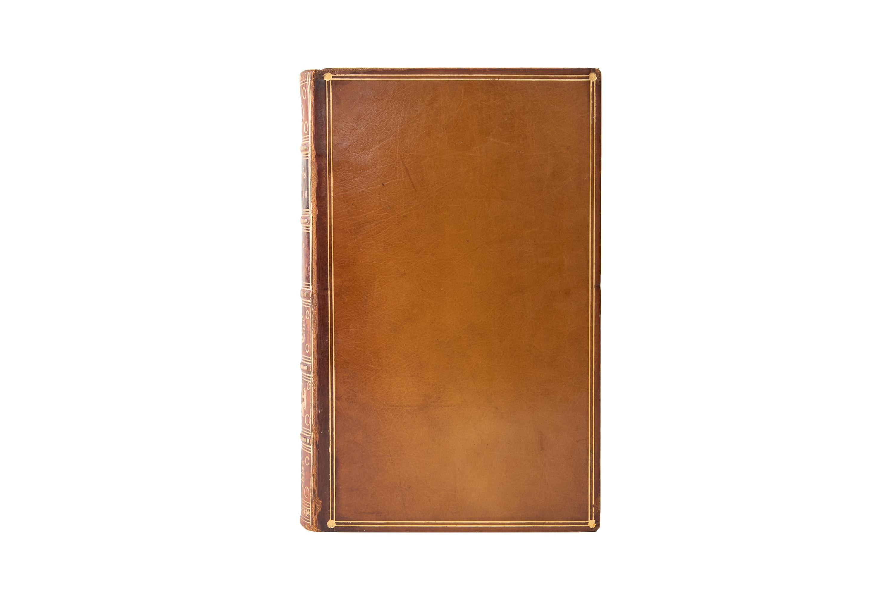 2 Volumes. Austen Henry Layard, Nineveh and its Remains. Bound in full tan calf with the boards displaying a double gilt-tooled border. The spines display raised bands, Egyptian panel details, and label lettering, all gilt-tooled with green and