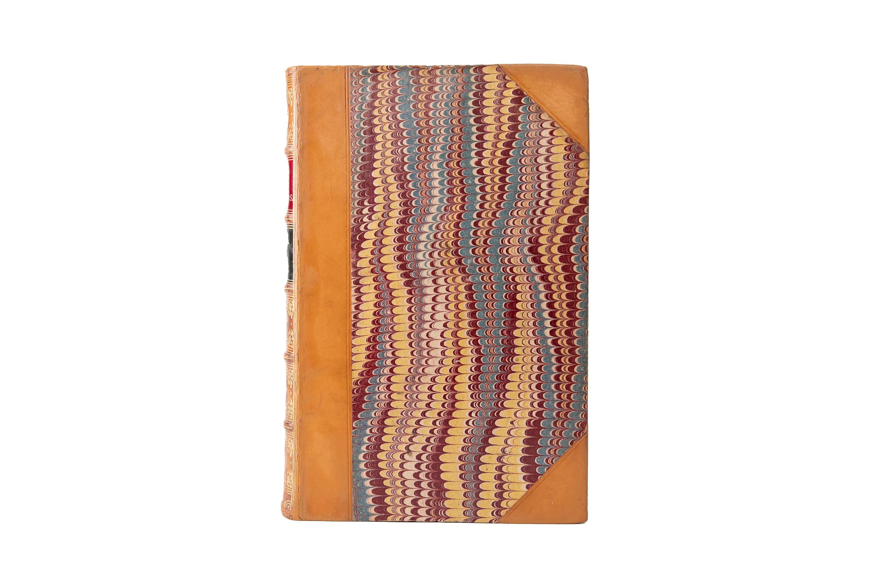 2 Volumes. Austen Henry Layard, Nineveh and its Remains. First Edition. Bound in 3/4 tan calf and marbled boards. The raised band spine is gilt-tooled with red and green morocco labels. All of the edges are marbled with marbled endpapers. Includes