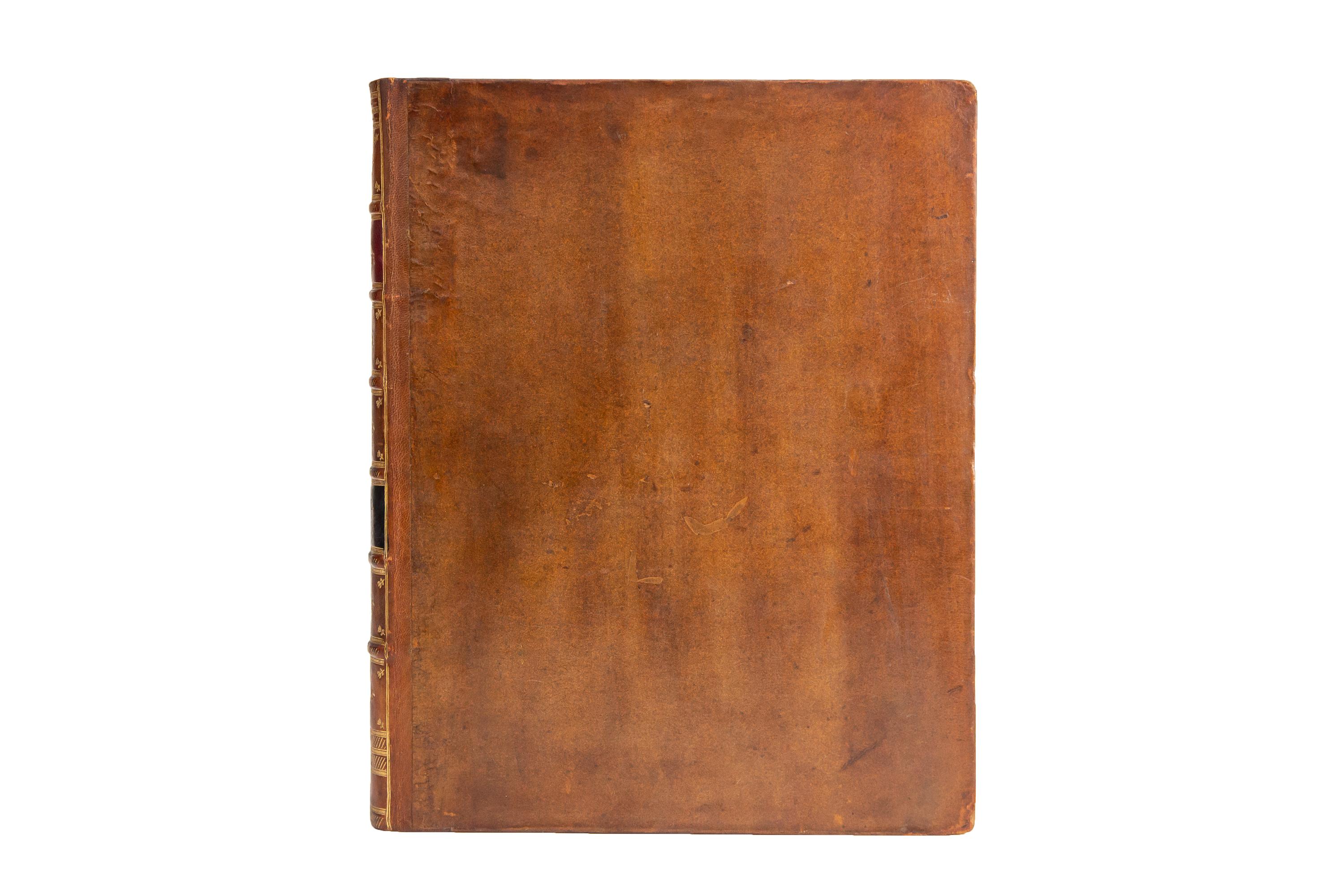 2 Volumes. Cervantes, Don Quixote. 1st Edition. Bound in full brown morocco. Raised bands, slashed with gilt tooling with panels displaying floral detailing in gilt tooling and labels in red and black morocco with gilt-tooled label lettering. The