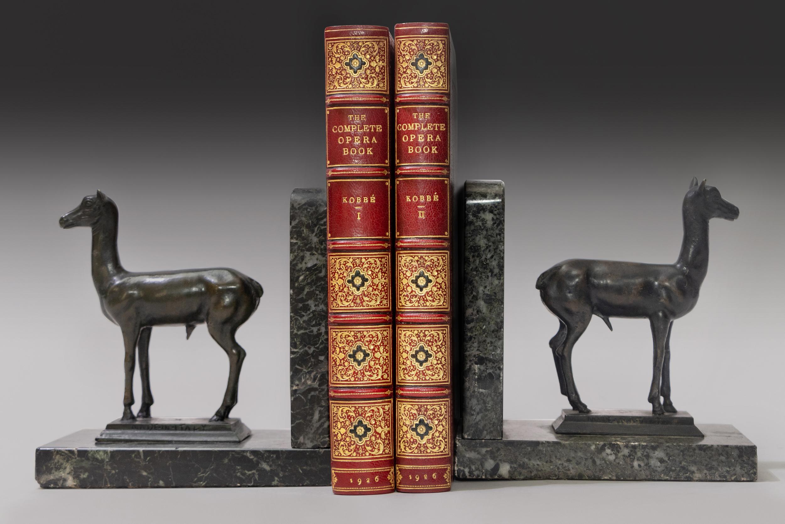 2 Volumes. Gustav Kobbe, The Complete Opera Book. Bound in red morocco. Gilt tooling on covers. Raised bands. Decorative gilt tooling on spine. All edges gilt. Marbled endpapers. Illustrated with 100 portraits in costume and scenes from opera.